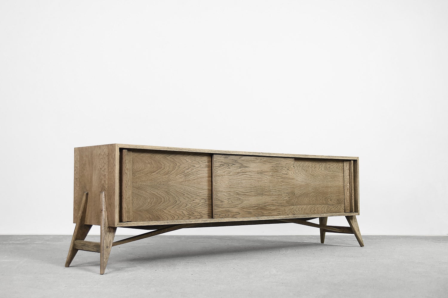 This organic sideboard was made in Finland during the 1960s. It was finished with oak wood, highly valued in the northern regions of Europe, with regular and clean grains and a natural, straw color. The wood was additionally brushed, which