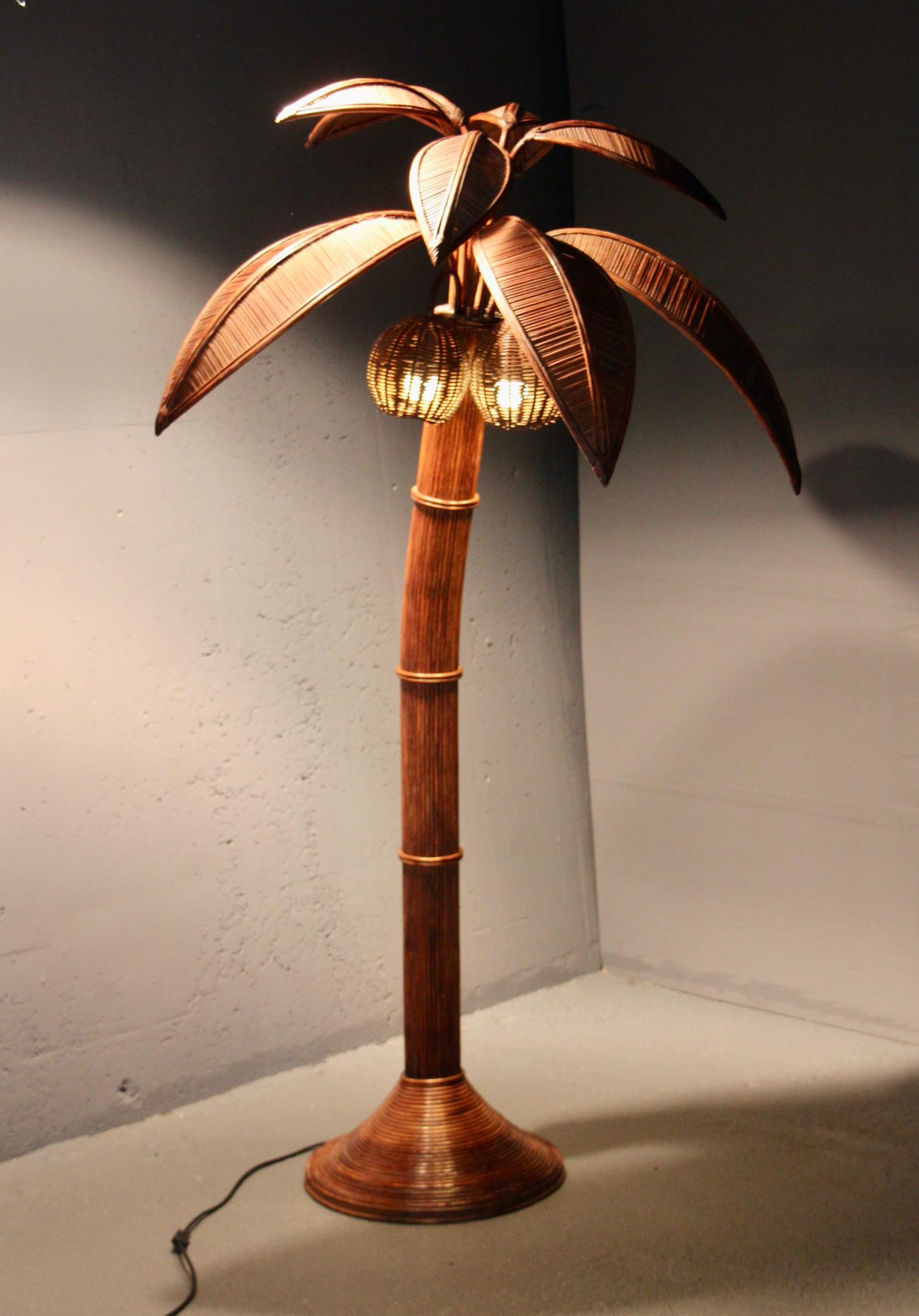 Original late 1960s life-size six-foot-tall palm tree floor lamp sculpted from stick rattan and wicker with removable leaves and 3 coconut-shaped lights attributed to Mario Lopez Torres. 