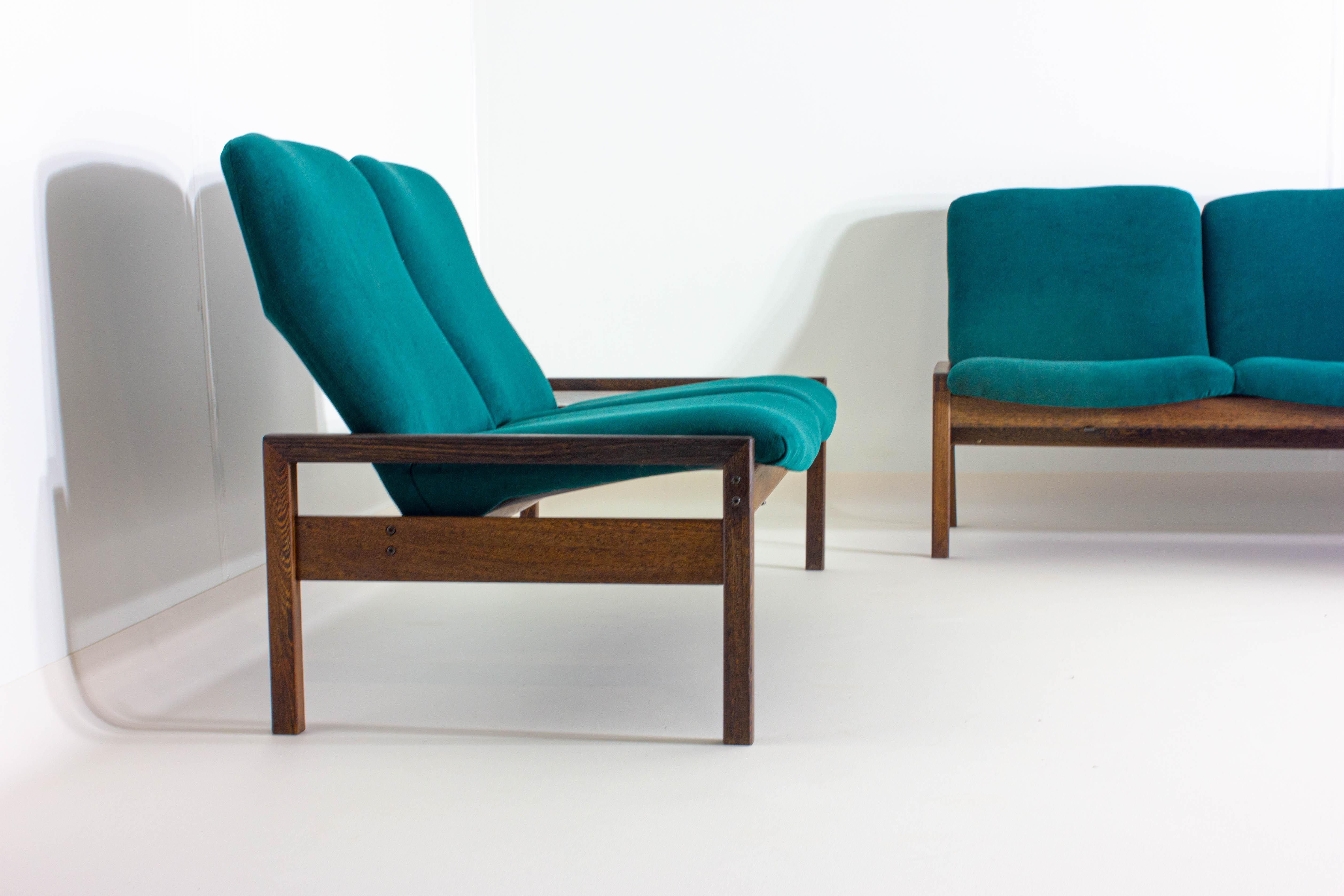 Adorned in a luxurious petrol green upholstery, this unique set by georges van rijk for beaufort exudes a cool, confident vibe that’s both retro and refreshingly contemporary. The vibrant green shade is a nod to the bold color palettes of its era,