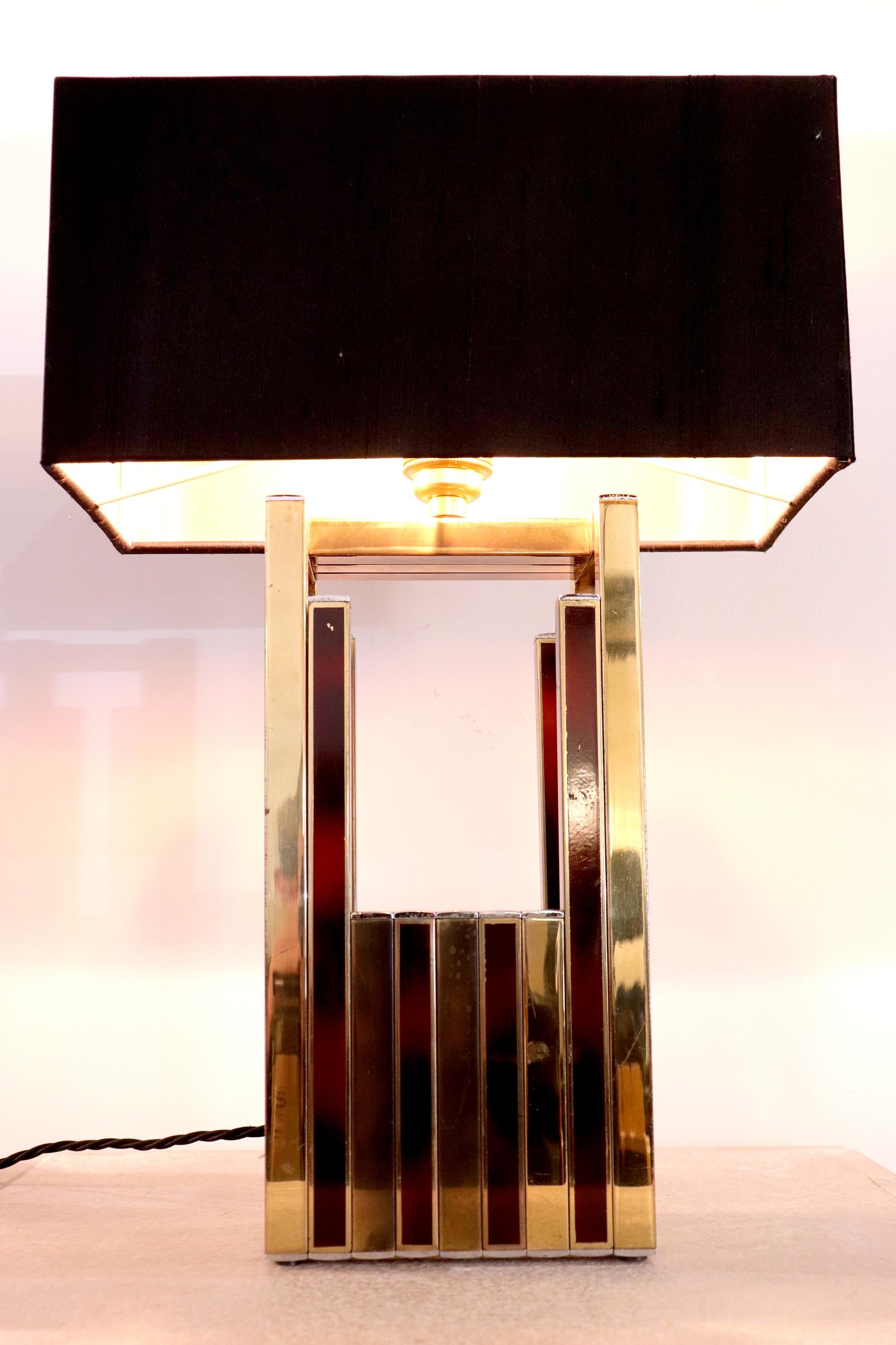A 1970's table light by Willy Rizzo for BD Lumica, 1970's.

This rare light features a beautiful brass and tortoiseshell coloured enamel in an interchanging pattern.

Recently rewired and comes with the shade. 

