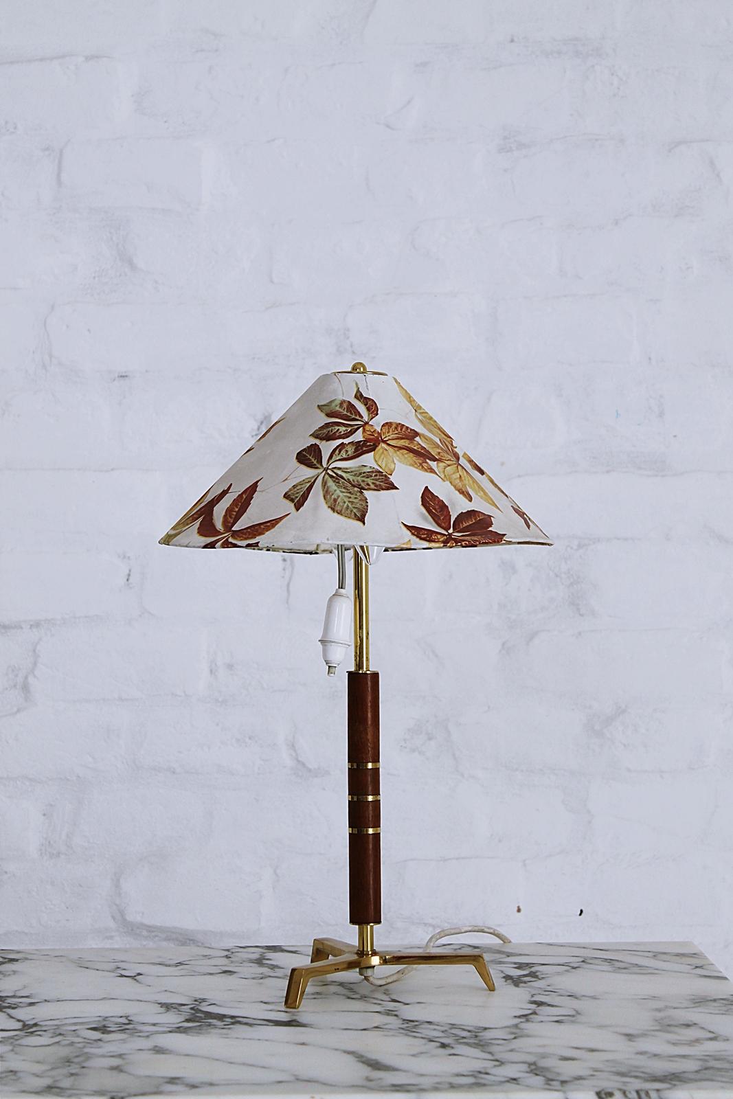 Very rare and stylish Austrian origin tripod table lamp with brass feet, teak and brass bands around the base. 
Attributed to J. T. Kalmar
 2x E 14 bulb
 Any type of light bulb can be use.
In working condition original wiring. Exception