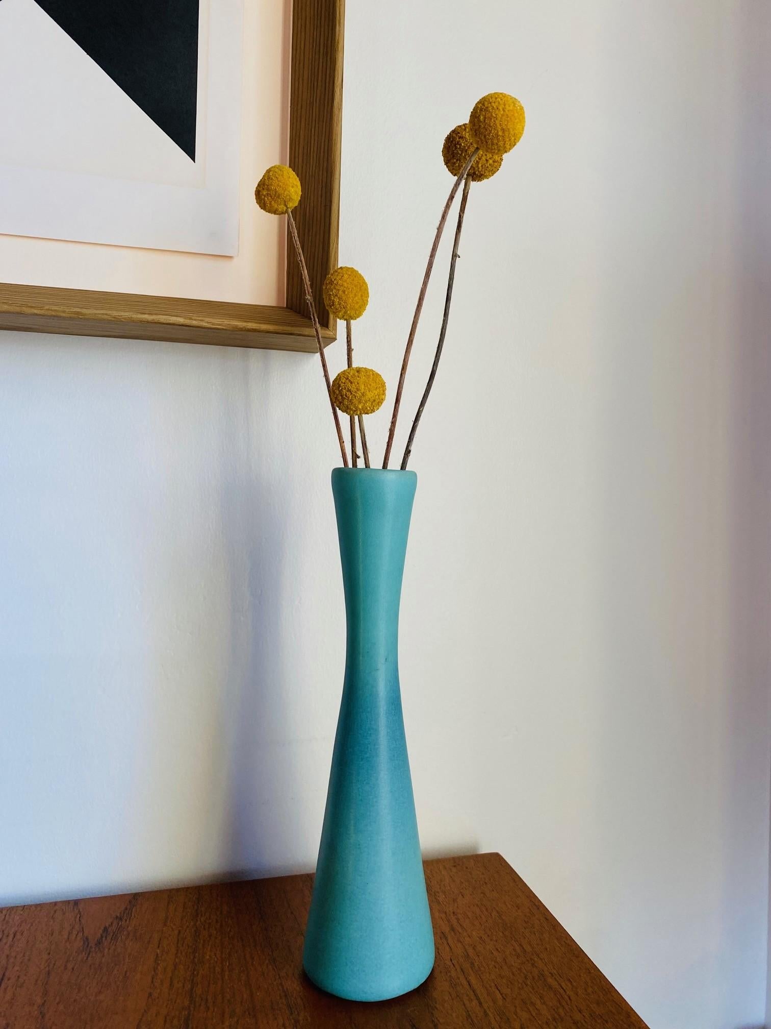Beautiful ceramic piece by Van Briggle. This piece is unique and rare with its modernist essence based upon the history of its manufacturer.  Simple lines flow in the delicate turquoise hue evoking a timeless stance and presence.  Modernist and