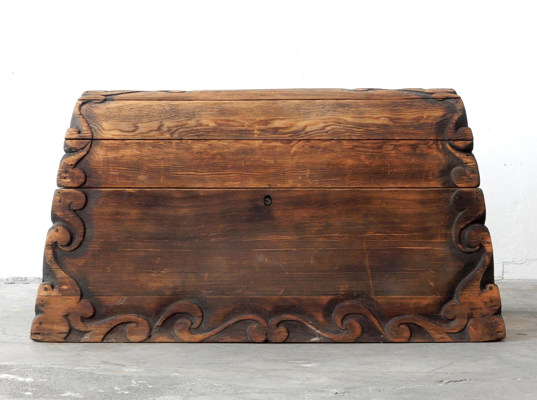 Incredible ornately carved cedar hump blanket chest.
Scroll work carving on edges and top.
Very large, thick and heavy piece all fashioned together with wooden pegs.
Large metal door hinges support lid. Barrel lock, no key,
circa 1960s,