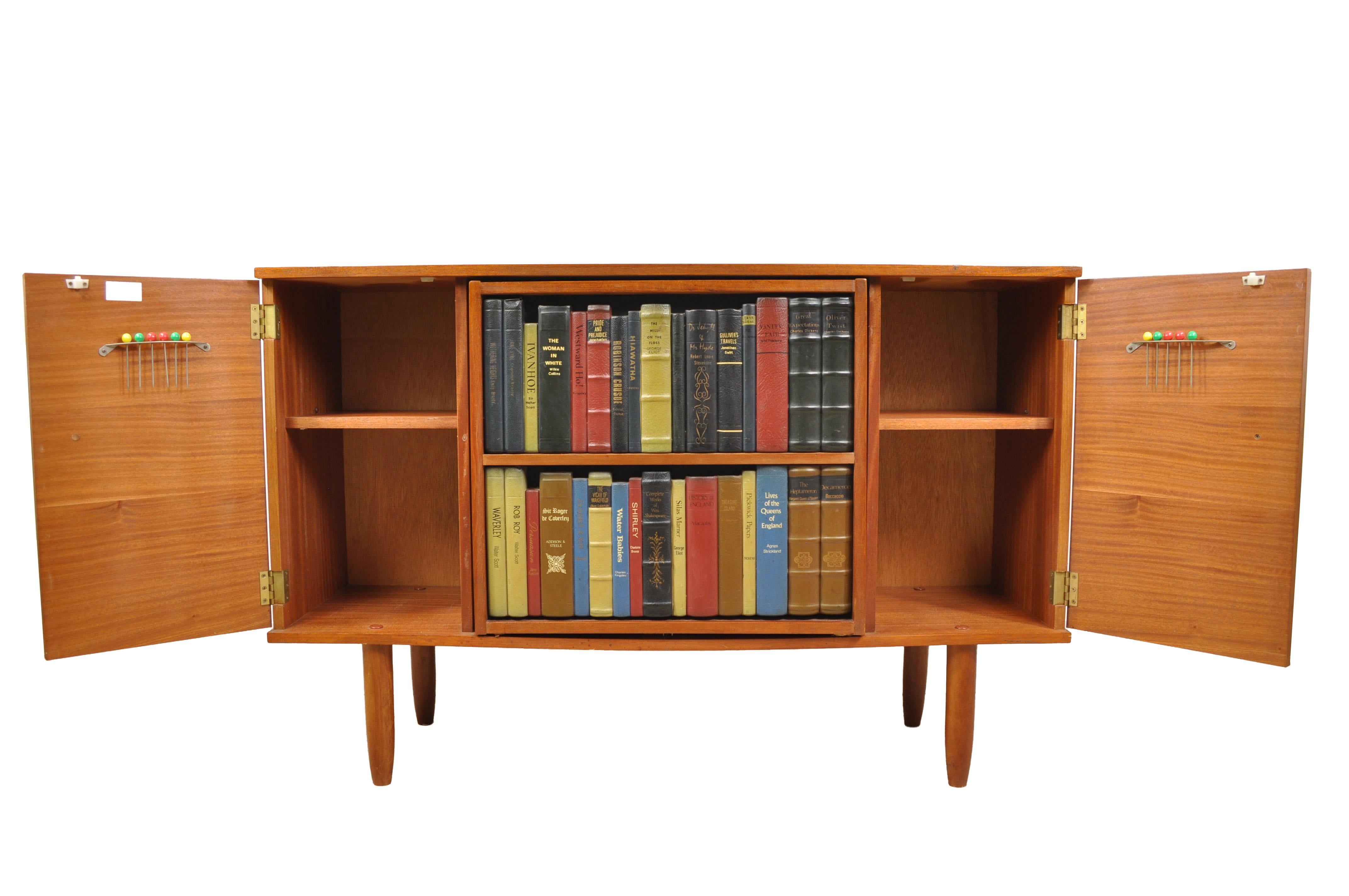 Rare Mid-Century Modern teak server or credenza with swinging “library” drinks cabinet. Doors open for extra storage. Great conversation piece.