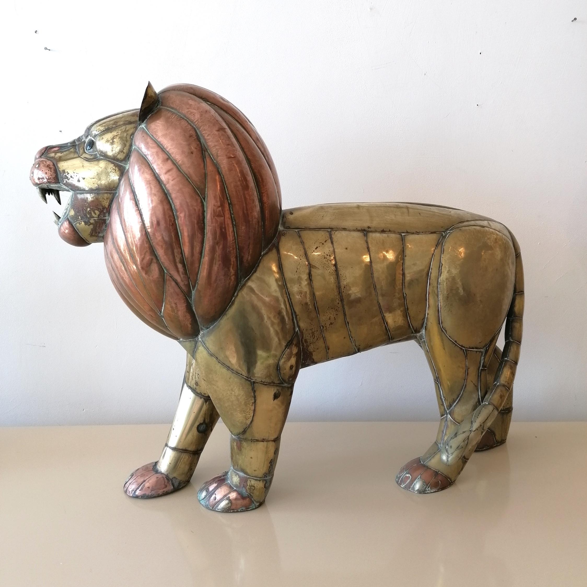 A monumental lion sculpture by renowned Mexican artist Sergio Bustamante 1970s. The figure is modelled from an intricate welded patchwork of brass & copper sheet. Lion has glass eyes.
No signature, but this is fairly common with the metal