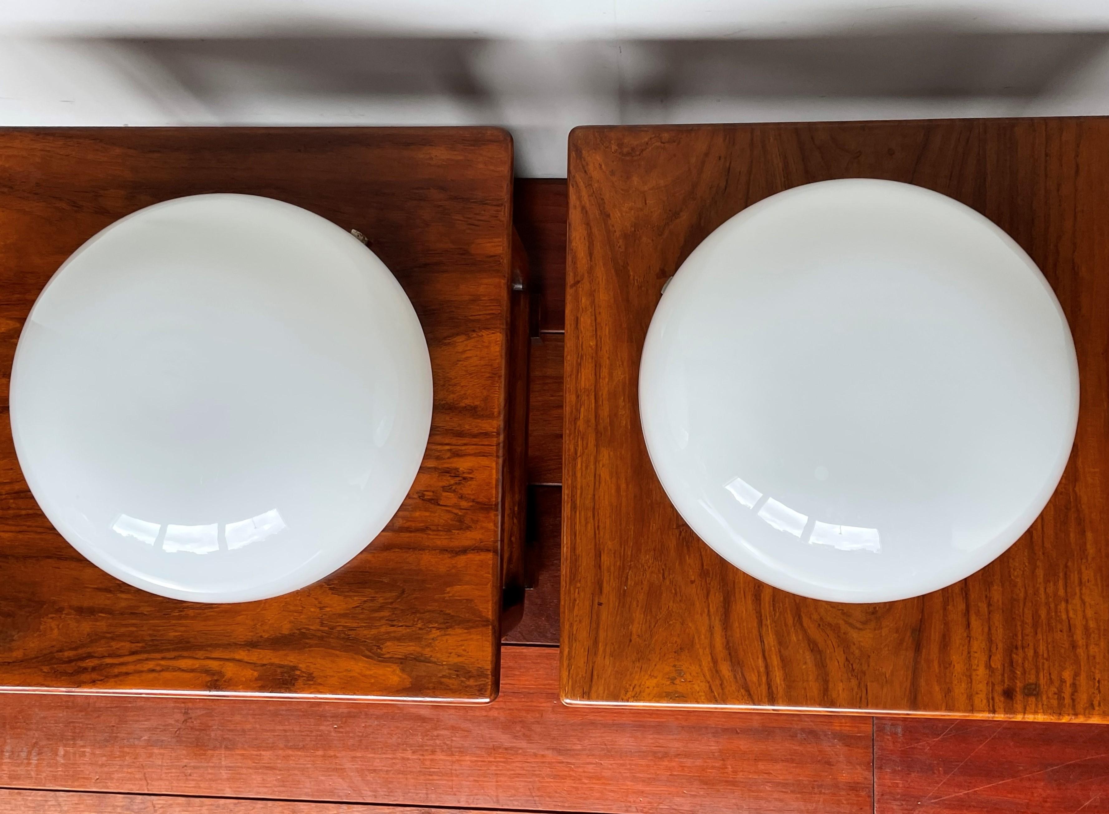 Very cool looking and timeless pair of European flushmounts from 1950-1960.

These mid-century opaline glass flush mounts have a very pleasing to the eye design and their timelessness make them suitable for other kinds of interiors as well. The