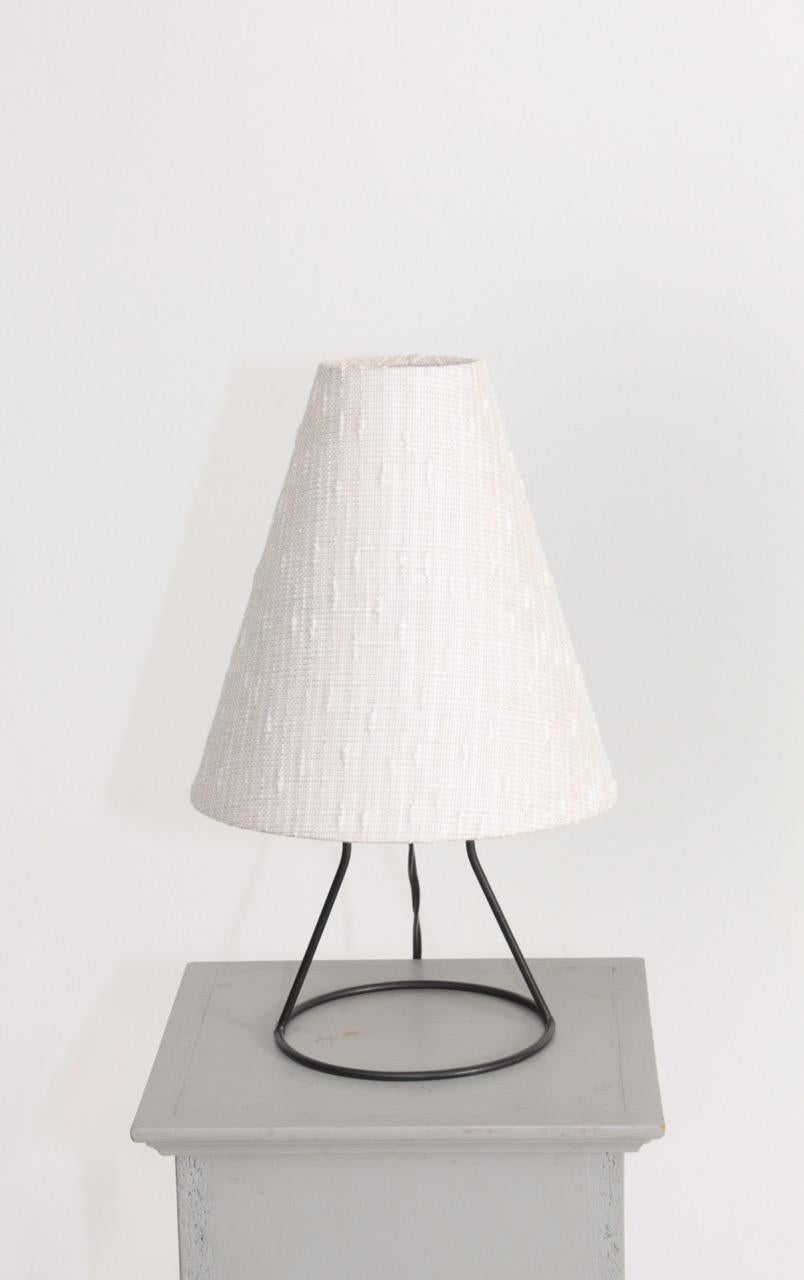 Table lamp in patinated iron and new lampshade. Made in Denmark. Original condition.