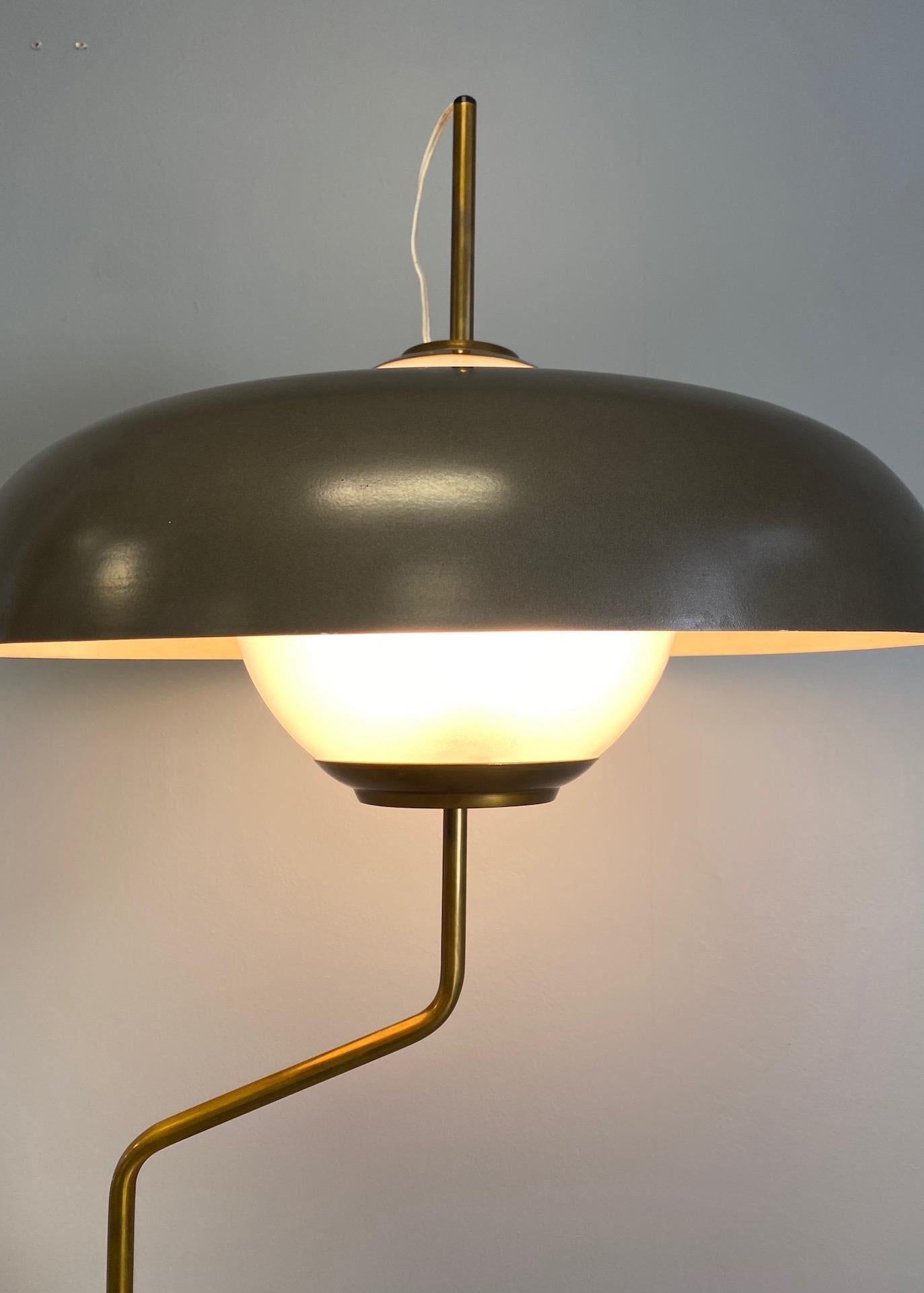 Table lamp, model Lte5, produced by Azucena. Shaped granite base, brass metal mounts and enameled aluminum shade. Three sockets concealed inside of a frosted glass globe.
 
  