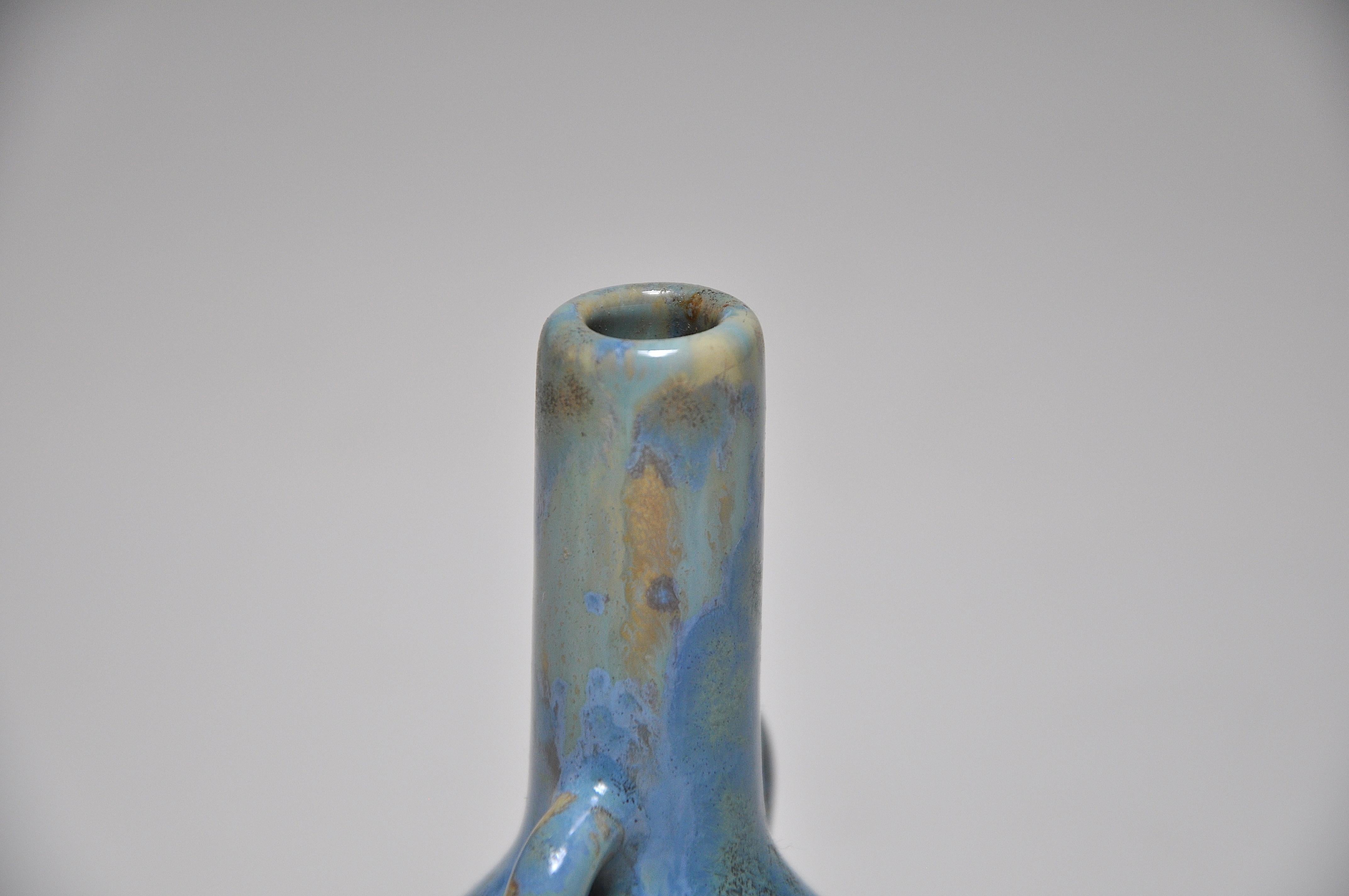 An exquisite rare miniature stoneware vase of bulbous form, with tiny twin handles and a long neck, covered with a flowing strongblue glaze, crystalline in places, on a yellow ground. By the ‘Pierrefonds’ French ceramic studio in Oise, Picardie,