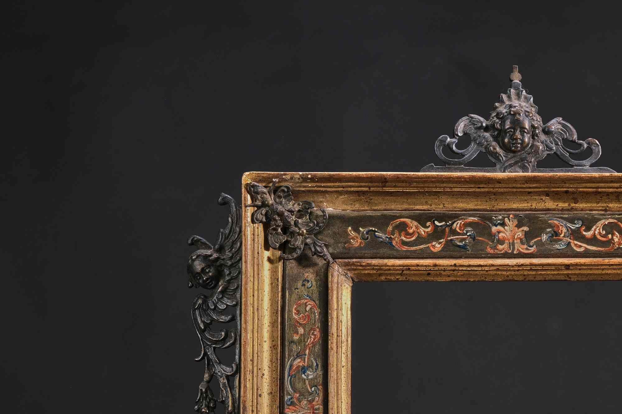 Rare gilded wooden frame qualified by a polychrome painted metal band with tiny foliage ornaments. Silver metal sconces chiselled with cherub heads between scrolls. Rome, 17th Two corner mounts in the frame are complemented by other elements HD