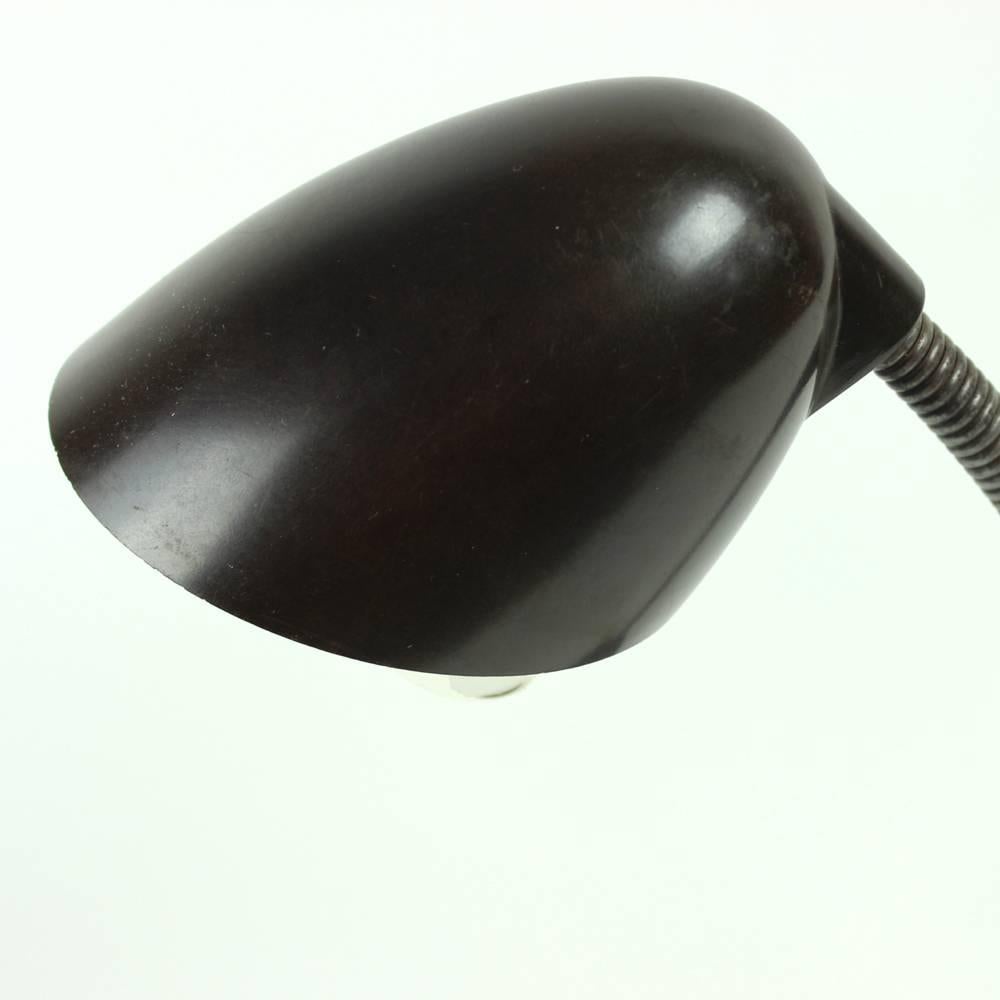Unique and rare mini version of the iconic table lamp by Eric Kirkman Cole. Bakelite base and shield with a gooseneck for great adjustability of the lamp. Miniature version of this lamp is quite rare and can be hardly found. Very good condition with