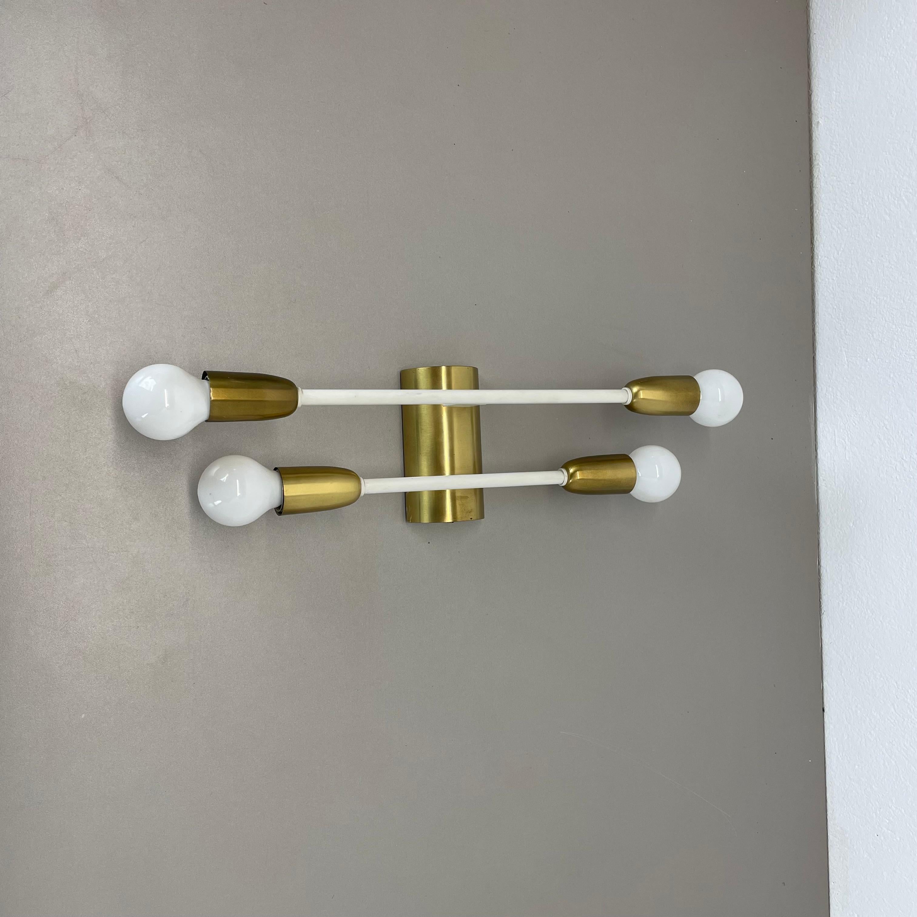 Article:

brass theatre wall light



Origin:

Italy



Age:

1950s


This modernist light was produced in Italy in the 1950s in Italy. It is made of brass and metal with 2 tube form element at the front in original white lacquer tone. the light has