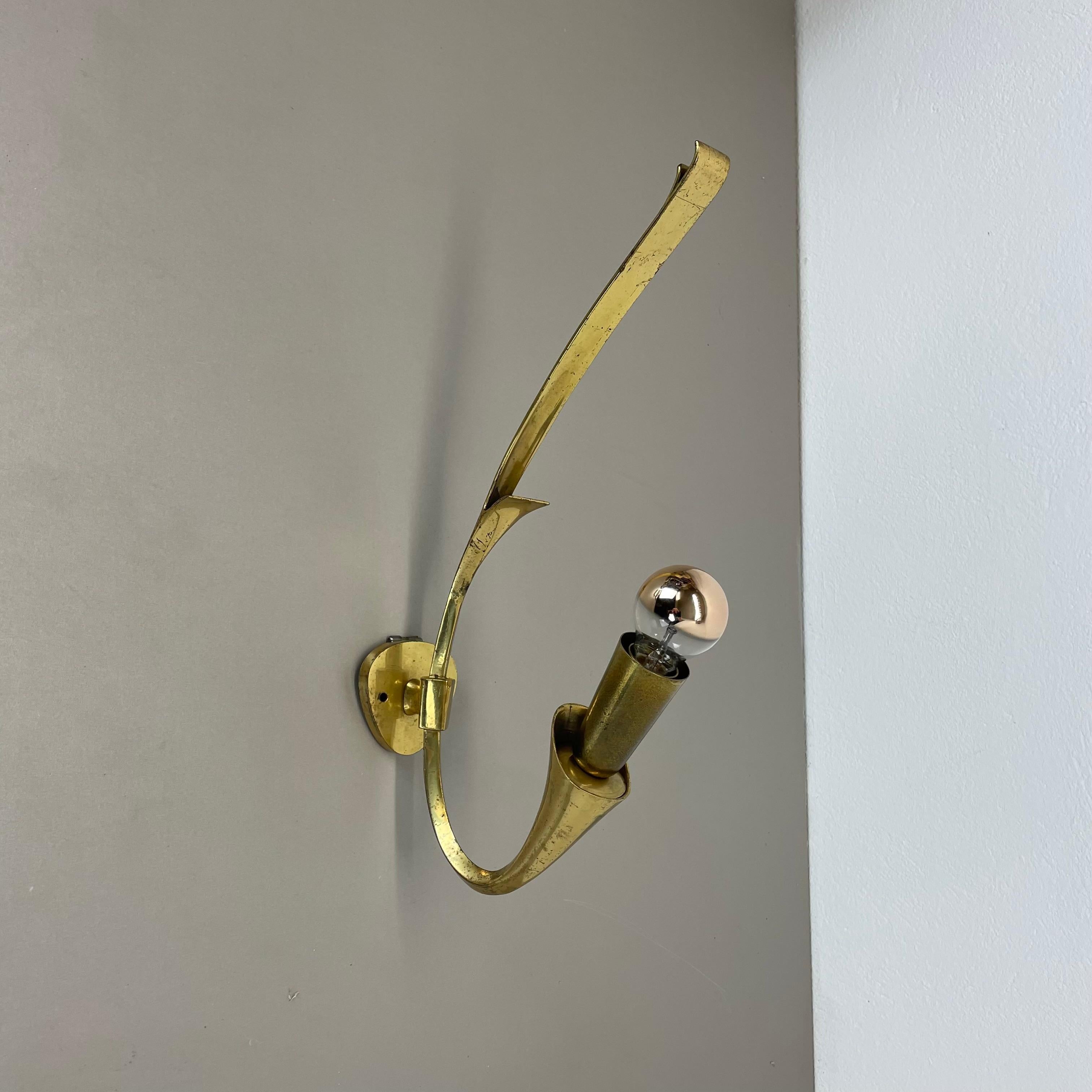 Article:

brass theatre wall light



Origin:

Italy



Age:

1950s


This modernist light was produced in Italy in the 1950s in Italy. It is made of solid brass with a nice looped form with one socket for light bulbs on the front. the light has a