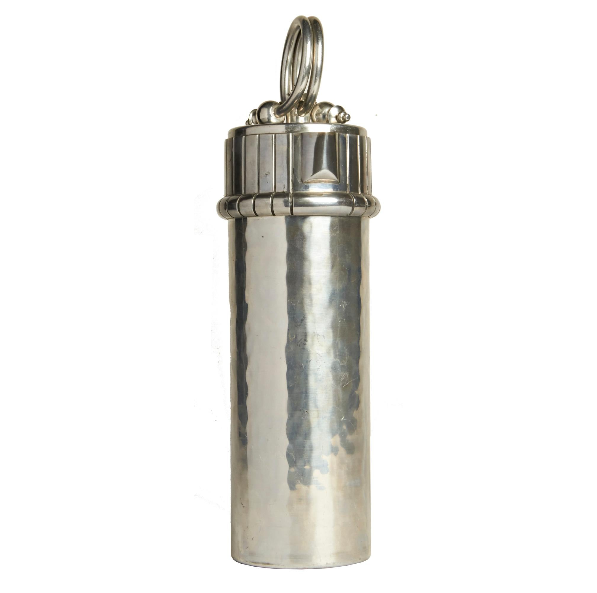 This beautifully designed, near mint, Art Deco cocktail shaker was designed by Fredrick Buehner for his Buenilum range of aluminum products first trademarked in 1933. This particular example is NOS with a bright shiny exterior and showing no