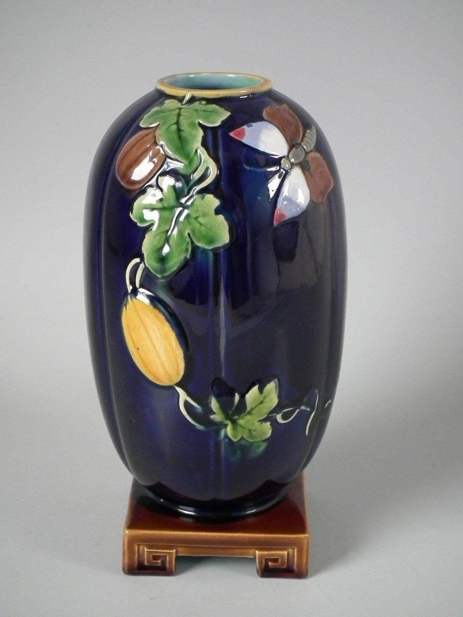 Minton Majolica flower holder which features a butterfly and leaves. Colouration: cobalt blue, brown, green, are predominant. The piece bears maker's marks for the Minton pottery. Bears a pattern number, '2210'.