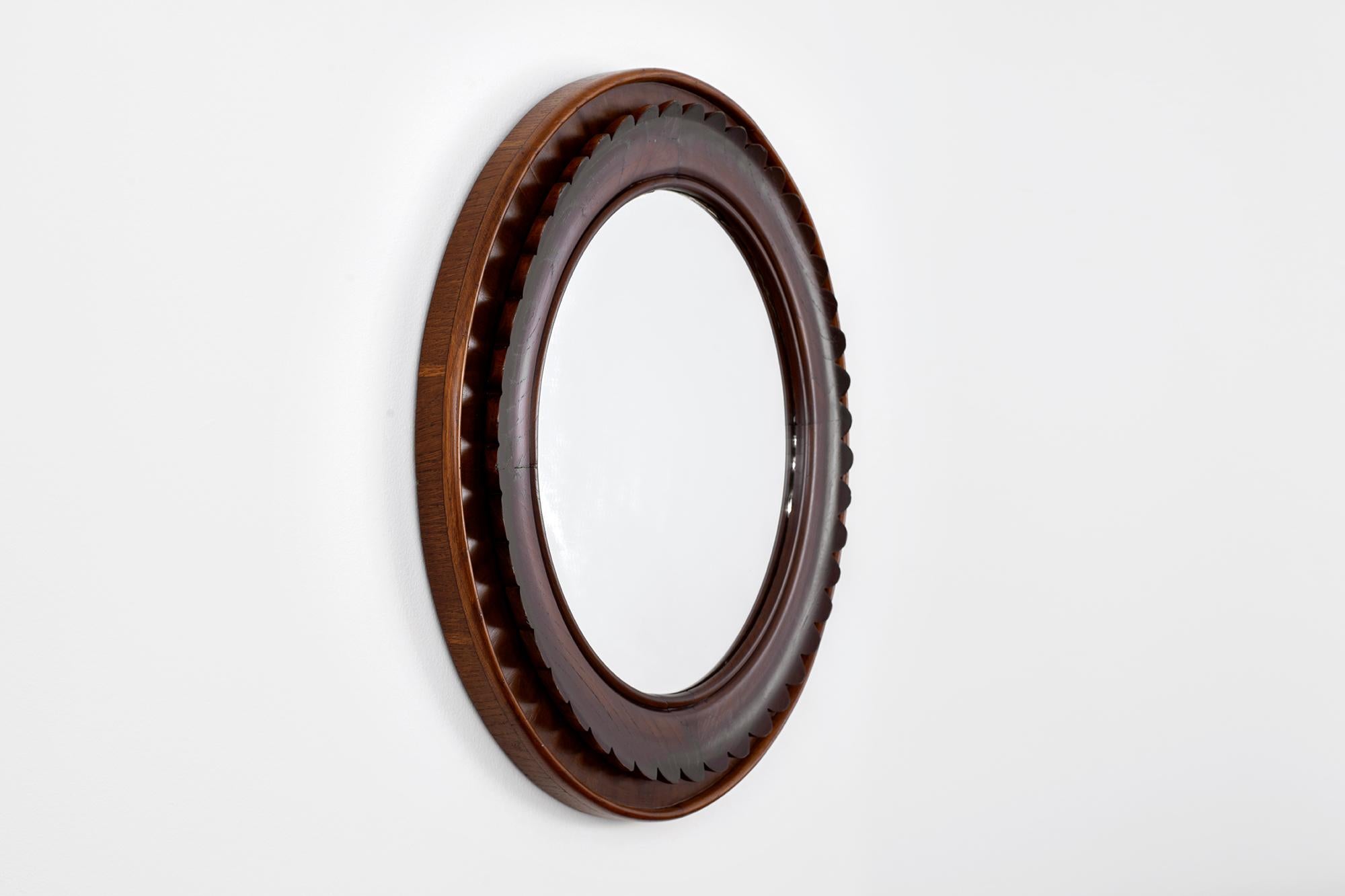 Italian mirror designed by Fratelli Marelli for Framar, circa 1940s.
Walnut and mahogany wood with intricate scalloped detailing and wonderful patina. 
A sculptural piece of art.