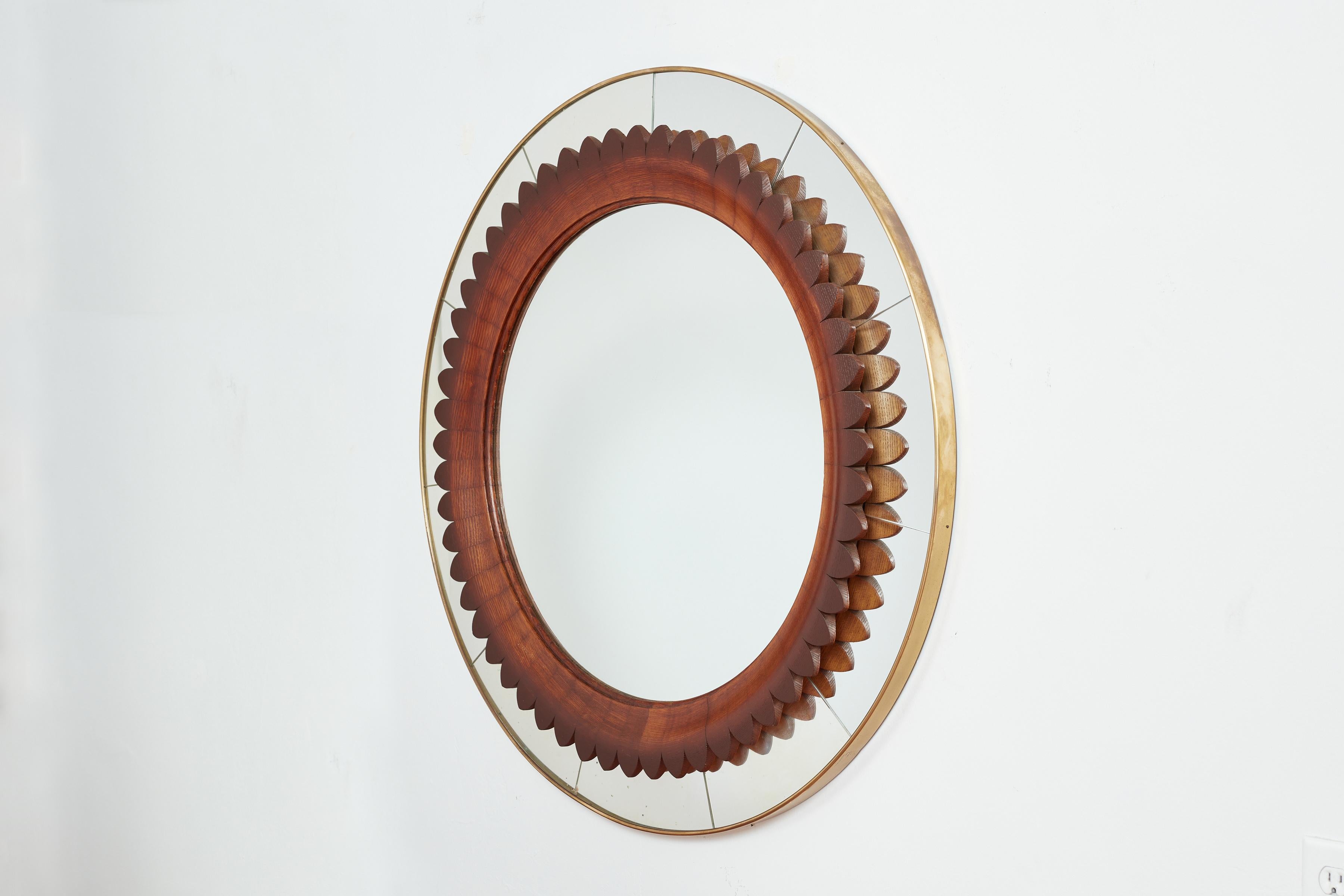 Rare mirror by Fratelli Marelli for Framar with hand carved walnut scalloped frame. 
Original mirror with brass round frame
Exquisite craftsmanship , Italy 1940s