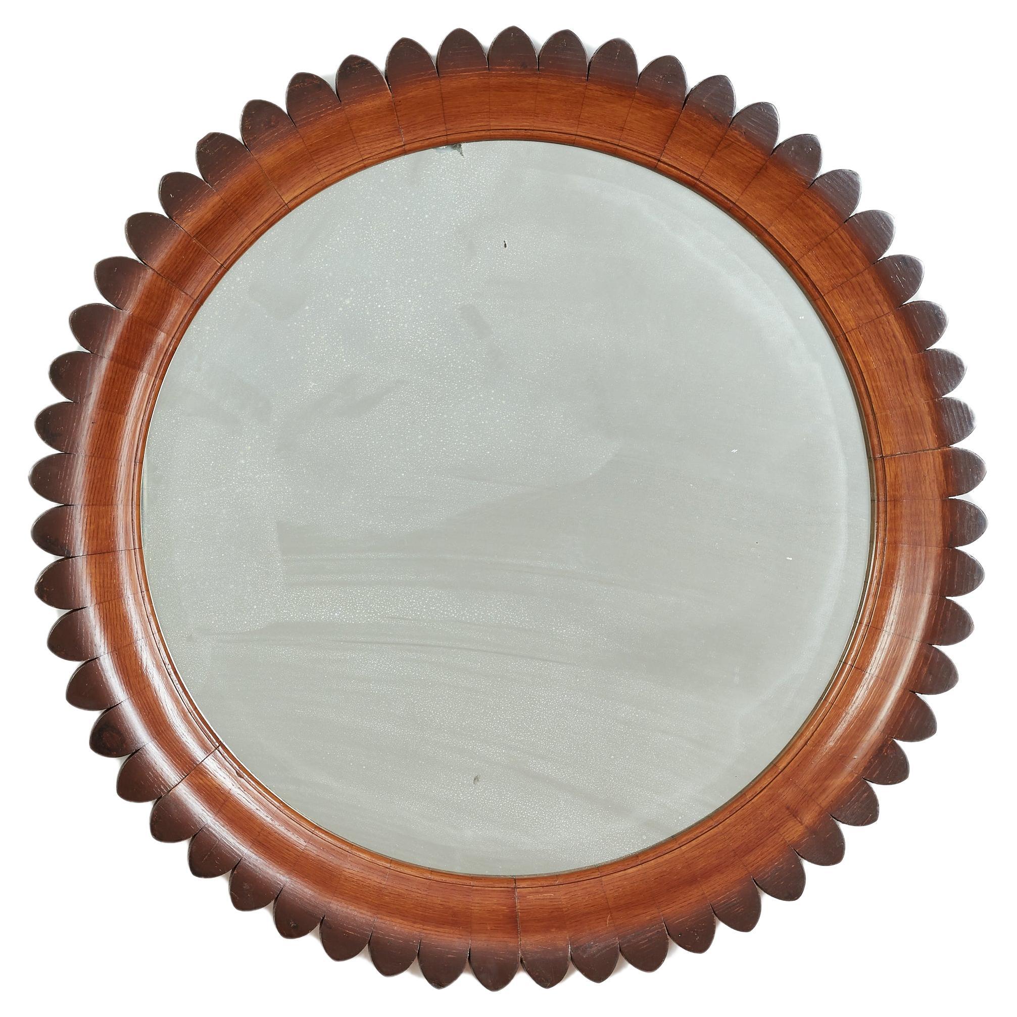 Exquisite mirror by Fratelli Marelli for Framar with hand carved  walnut scalloped frame. 
Original mirror 
Exquisite craftsmanship.

Italy 1940s.