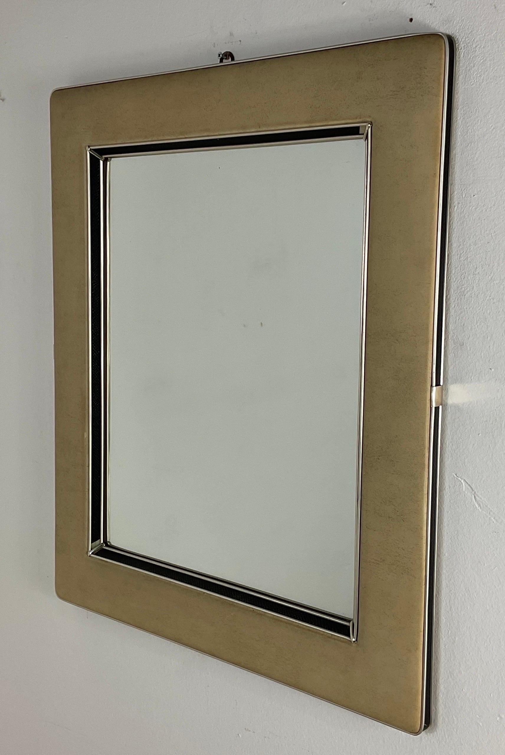 Rare mirror by Umberto Mascagni of the fifties. Wooden frame with vinyl leather frame. Good condition.