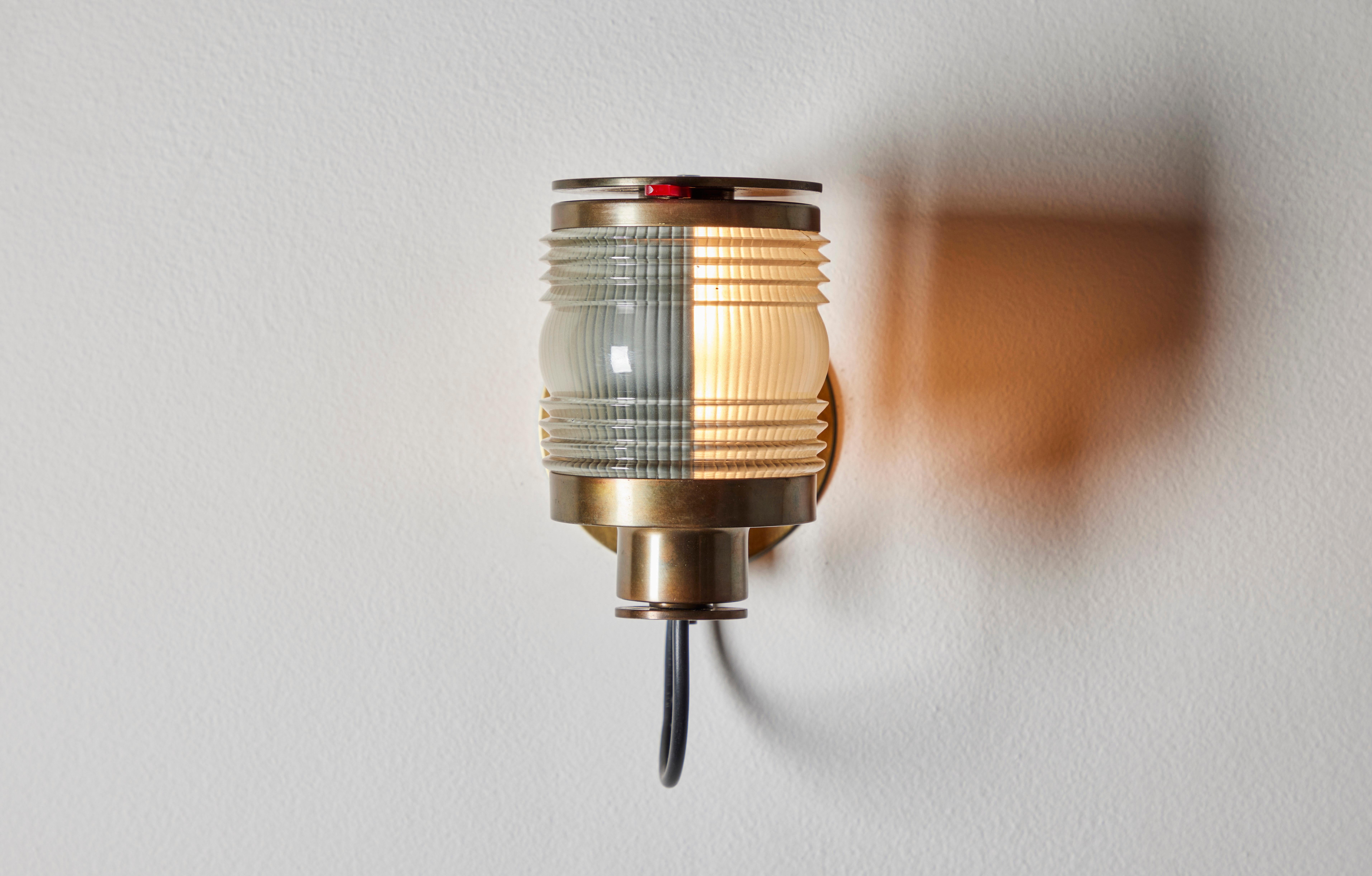 Rare Model 1138 single sconce by Joe Colombo. Designed and manufactured in Italy, 1963. Glass, brass. Adjustable shutter for directional lighting. Rewired for U.S junction boxes. We recommend one E14 40w maximum bulb. Bulb not included.