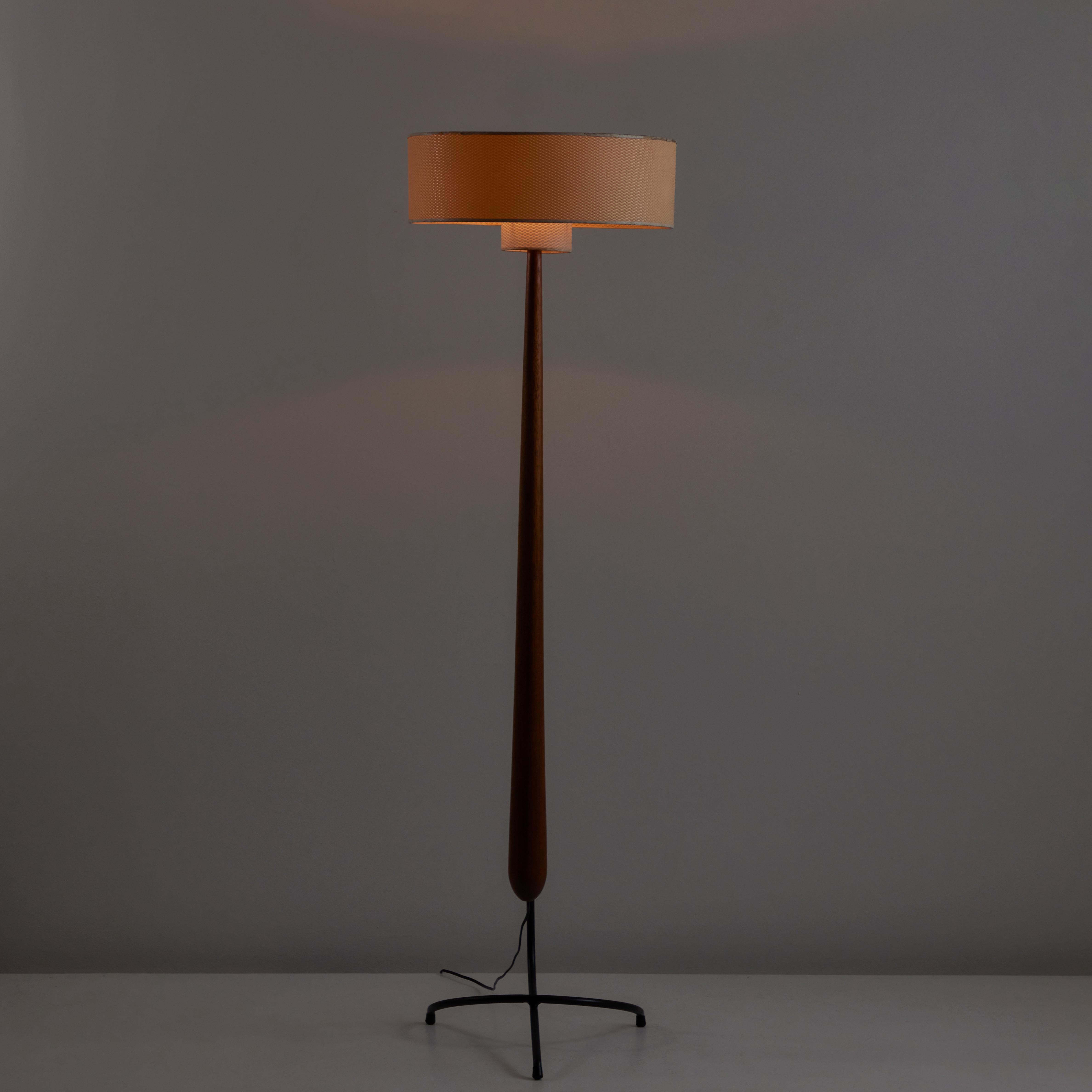 Rare Model 14.958 Floor Lamp by Rispal. Designed and manufactured in France, circa 1950. Rare sculptural floor lamp with slender custom wood stem, interlocking curved steel base, and double layered textured parchment shade. The floor lamp holds one