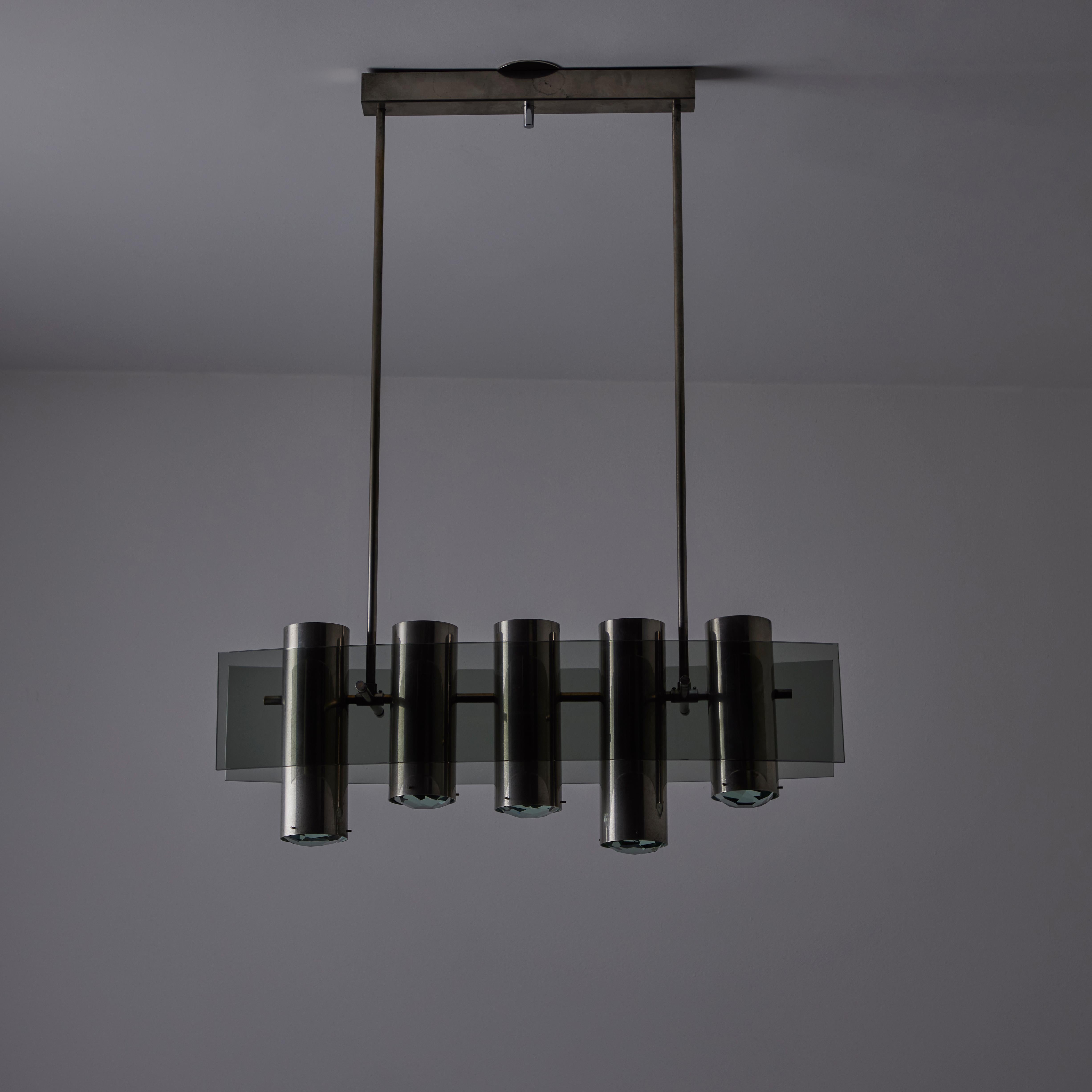 Model 2177 Chandelier by Max Ingrand for Fontana Arte. Designed and manufactured in Italy, in 1965. A rare linear chandelier comprising of five chrome cylinder spotlights and two curved panels of smoked glass. The cylinders each hold geometric cut