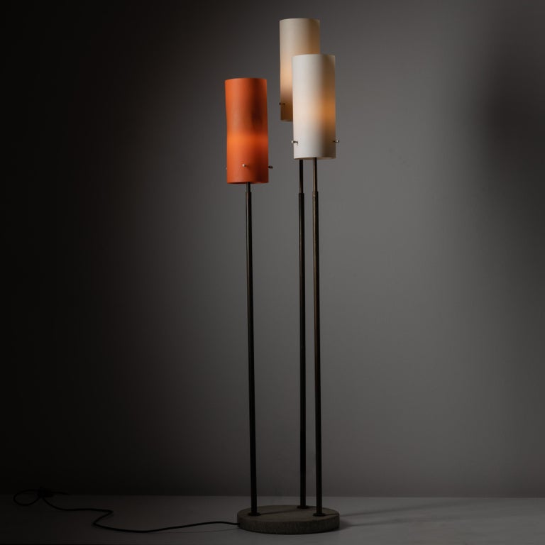 Rare Model 378 floor lamp by Tito Agnoli for Oluce. Designed and manufactured in Italy circa the 1960s. A trio of acrylic cylinders on individually and extendable brass stems. The telescoping stems allow for various height configurations. Holds