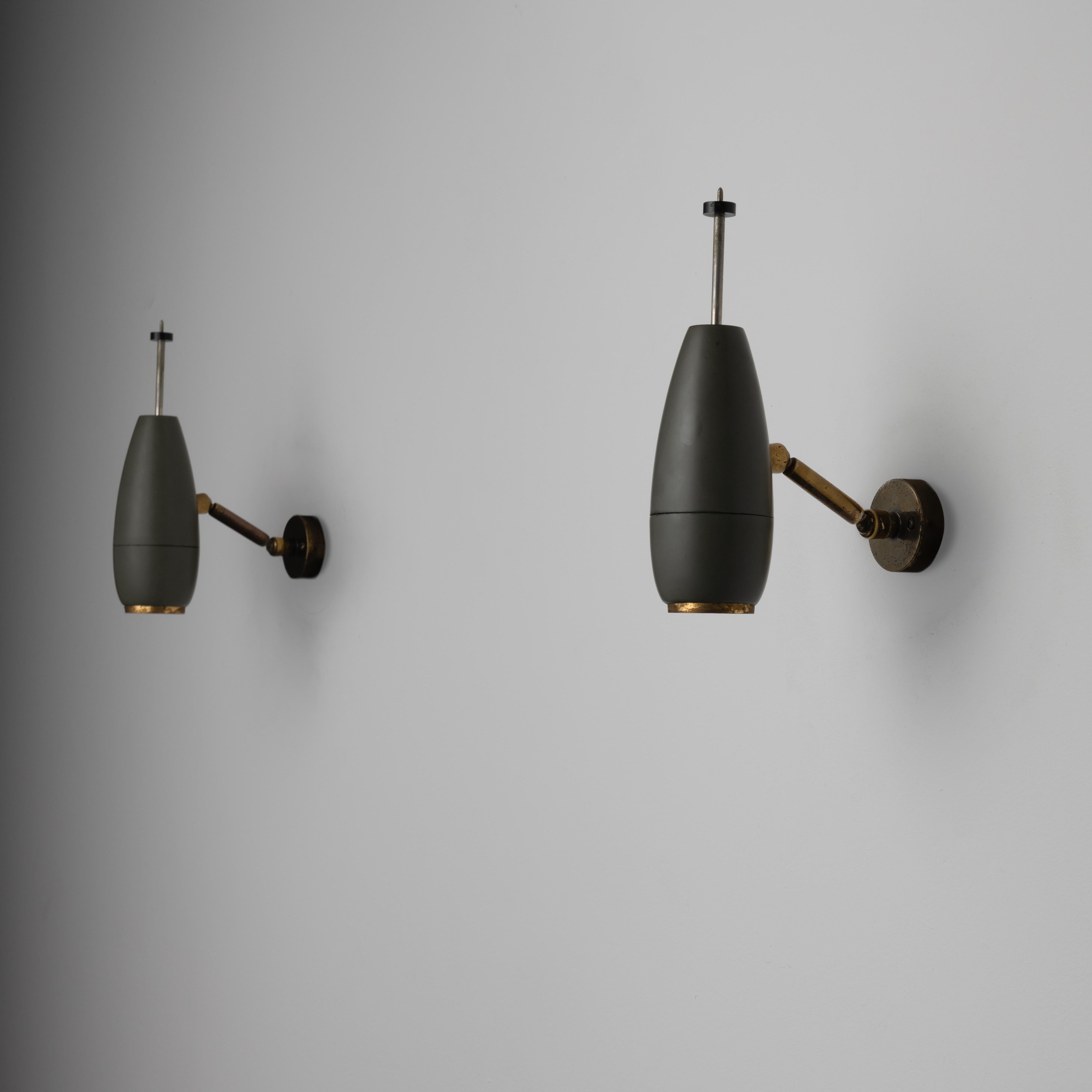 Model 577 Sconce by Oscar Torlasco for Lumi. Designed and manufactured in Italy, in 1961. Industrial and anatomical wall sconces with enameled torpedo body and adjustable diffusion intensity from rear end stem. These sconces each hold one E14