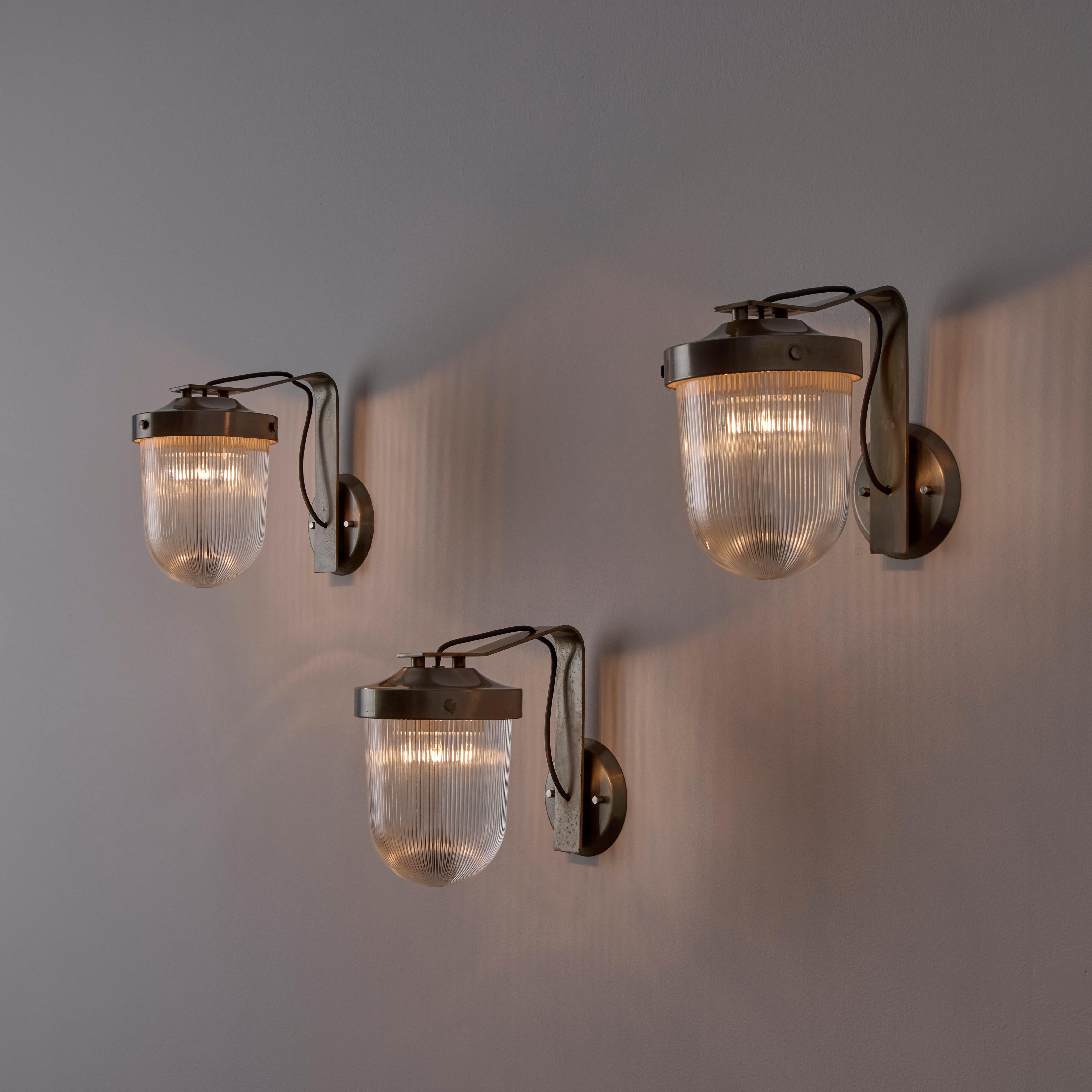 Rare Model G.A. sconce by Fulvio Raboni for Delitala. Designed and Manufactured in Italy, 1959. Curved brass armatures, paired with clear printed glass diffuser. We recommend one E27 40w maximum bulb. Wired for US. Bulb included as a one time
