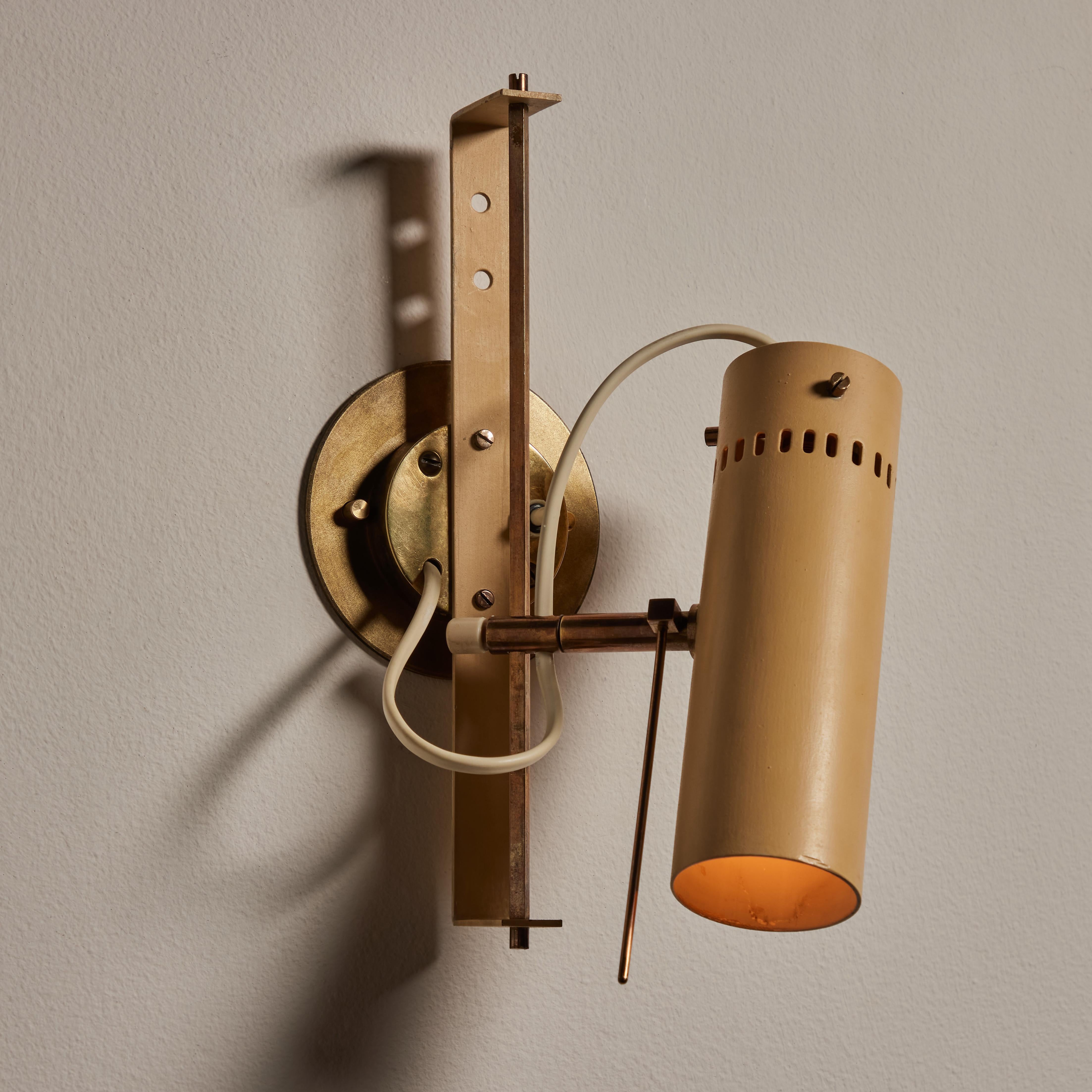 Rare Model No. 174 wall light by Tito Agnoli for Oluce. Designed and manufactured in Italy, circa 1950's. Brass, painted metal. Wired for U.S. standards. Adjust to various positions and heights. We recommend one E14 40w maximum bulb. Bulb not
