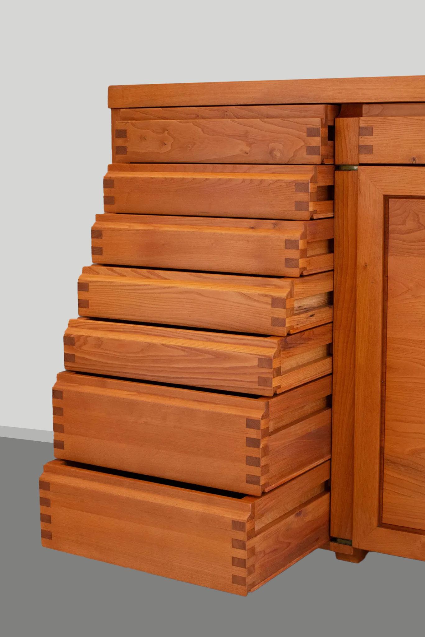 Pierre Chapo, sideboard, two-door and eight drawer sideboard model R13A, elm, France, 1964.  

This exquisitely crafted credenza combines a simplified yet complex design combined with nifty, solid construction details that characterize Chapo's work.