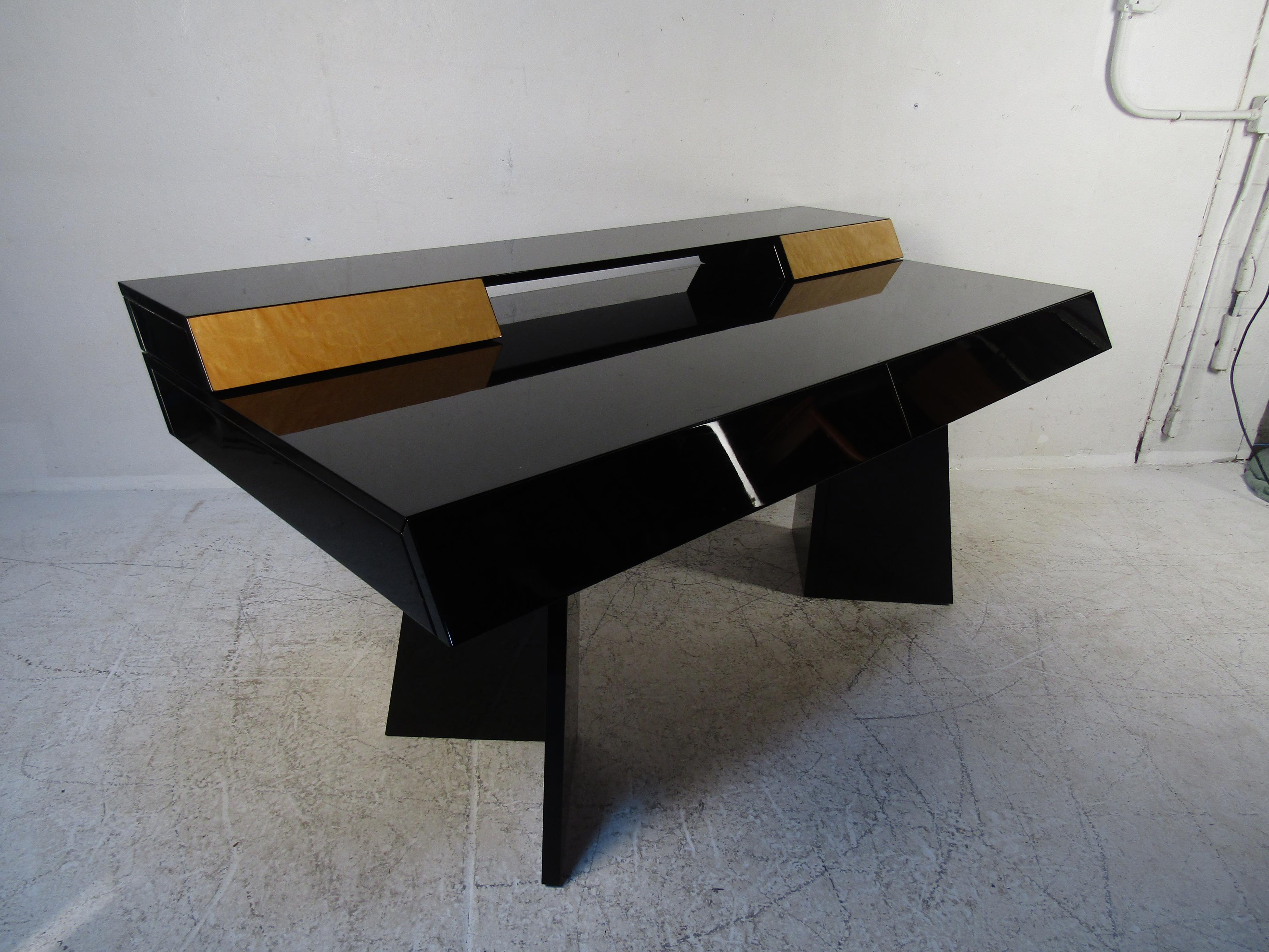 An elegant contemporary modern desk with a black lacquer finish and burl drawer fronts. This ultra-sleek Italian desk has four drawers ensuring plenty of room for storage and workspace. A one of a kind, two-tone desk, that easily blends with any