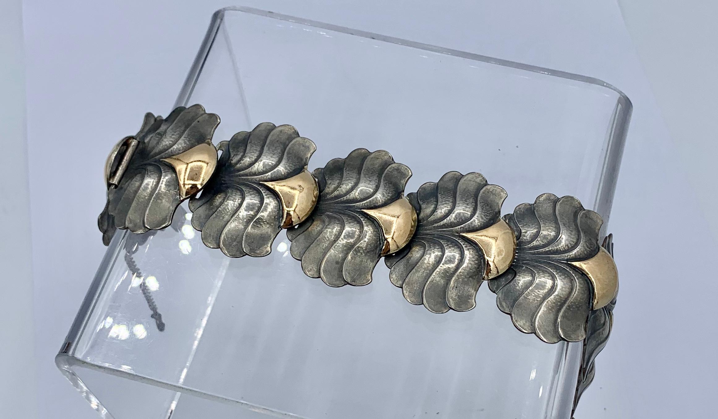 This is a rare and wonderful Modernist Art Nouveau Bracelet in Sterling Silver with 14 Karat Gold in an exquisite shell or leaf motif design dating to circa 1900-1930 in the Catalan style from Barcelona, Spain.  The Spanish modernist designs are of