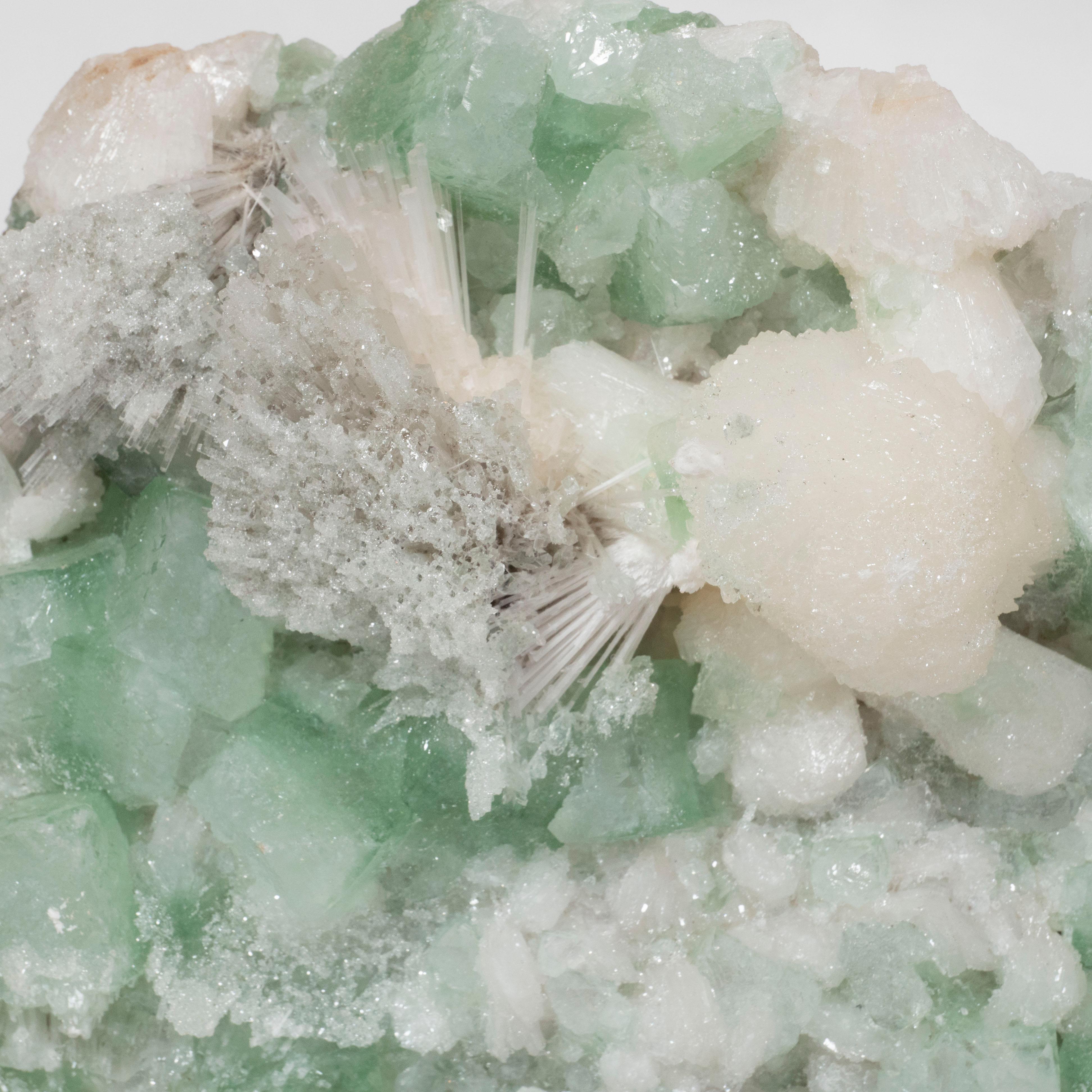 This rare and stunning modernist green rock specimen was mined in Brazil, during the 20th century. Composed of green apophylite and scolocite, this rock crystal offers a range of subtle natural hues from chalky emerald greens to dove grays all in a