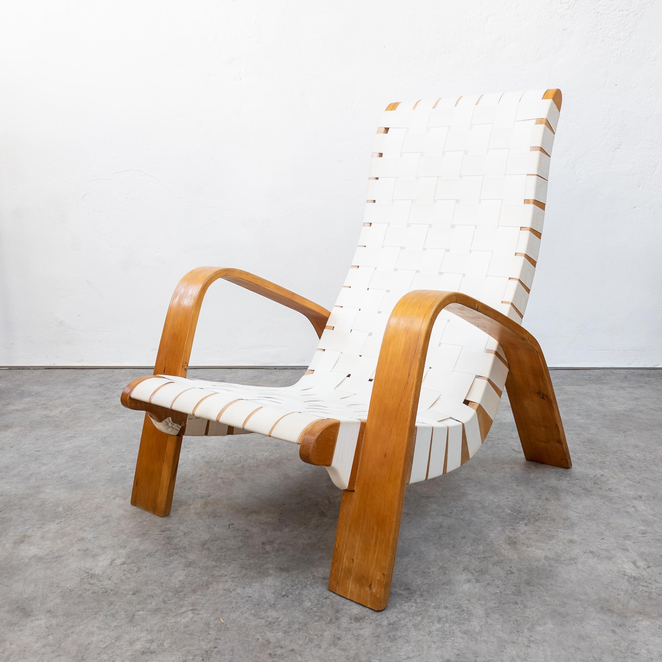 Unique lounge chair with footstool manufactured by Krásná Jizba, former Czechoslovakia in the late 1940s. Designed probably by architect Zdenek Plesník. Beautiful sculptural appearance. Made of beech wood, plywood and canvas webbing. Wood in