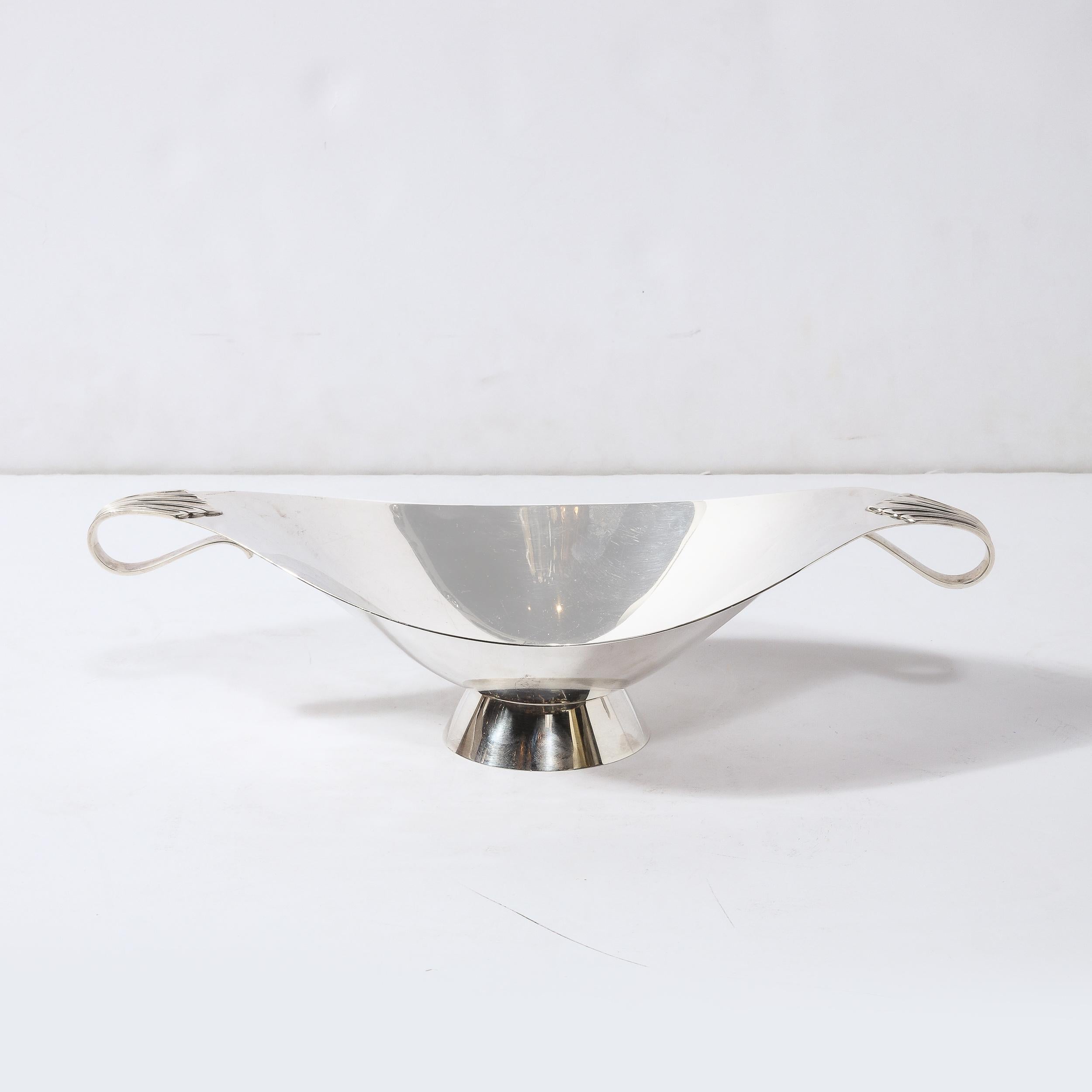 This rare Mid-Century Modern sterling silver centerpiece bowl was realized Tiffany & Co- America's premiere maker of luxury silver goods and luxury products since 1838. This piece was realized in the United States circa 1950, and is a first rate