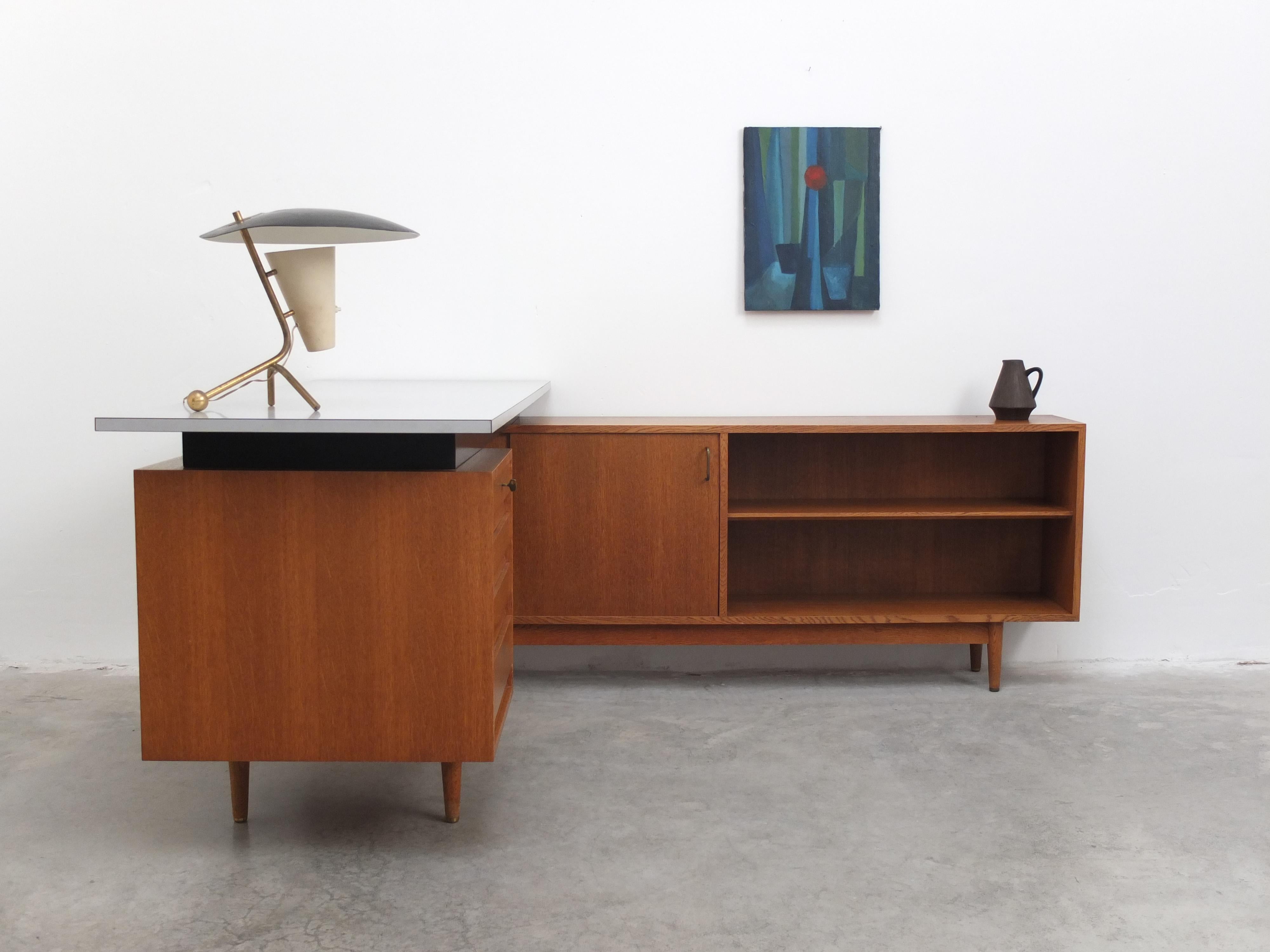 Fantastic writing desk from the ‘Abtracta’ series designed by Jos De Mey and produced in Belgium by Van Den Berghe-Pauvers during the 1960s. This rare L-shaped desk features a sideboard and one drawer cabinet made of oak with a great patina thanks