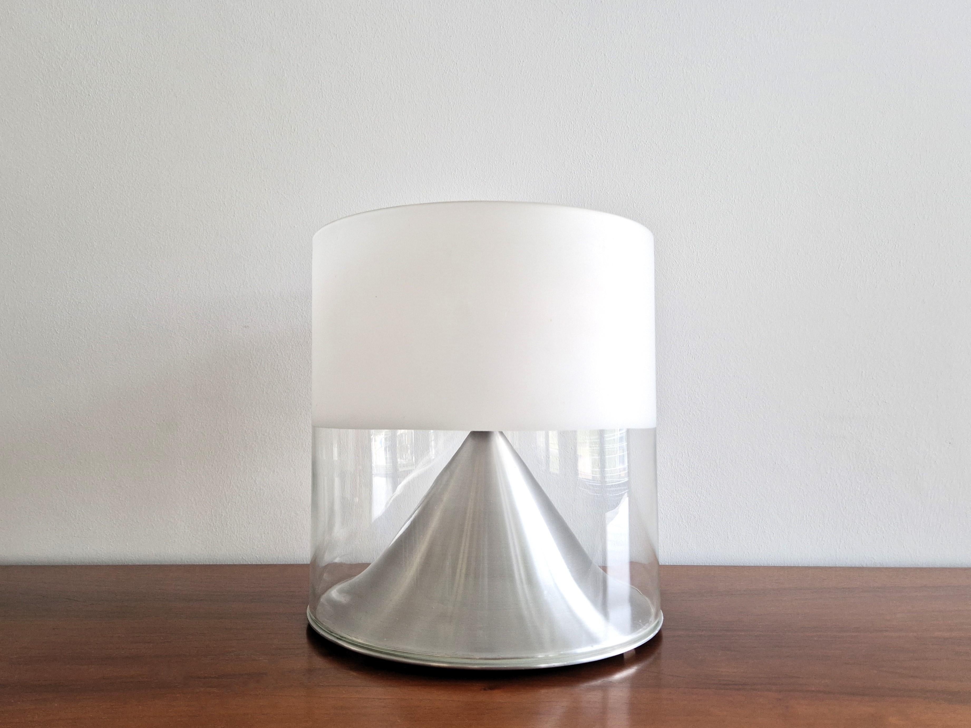 This rare table lamp, model 'Mont Cenis' was made by RAAK Amsterdam in the 1970's. It has an aluminum base with a glass tube, half clear and half opaline. A very special design where the bulb is hidden 