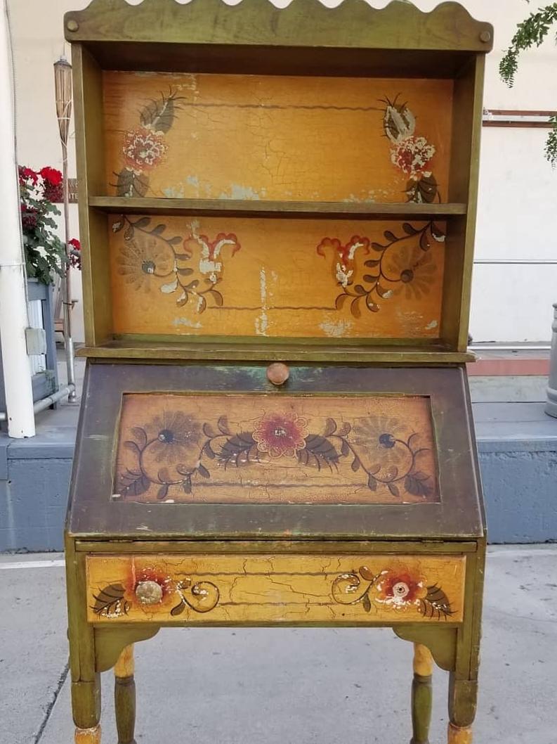 A scarce Monterey Furniture drop-front secretary desk in green with hand painted floral design. Made by Mason Manufacturing Company of Los Angeles, California, circa 1930s. This piece has the branded mark 