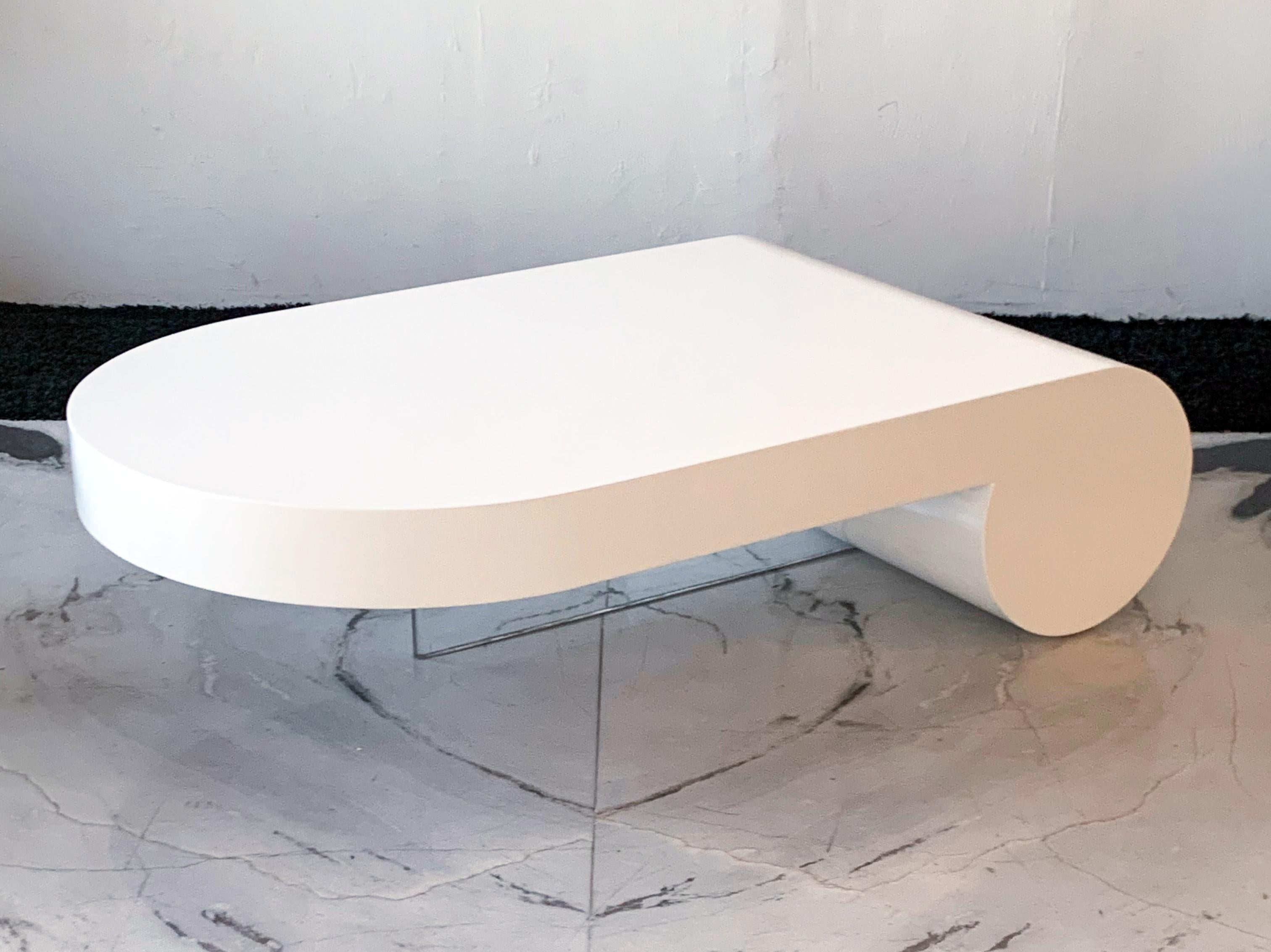 Available at the gallery right now, we have a stunning, very large coffee table designed by Vladimir Kagan for Directional. This coffee, called the Plateau table features a waterfall edge with an acrylic leg almost an identical leg / support to