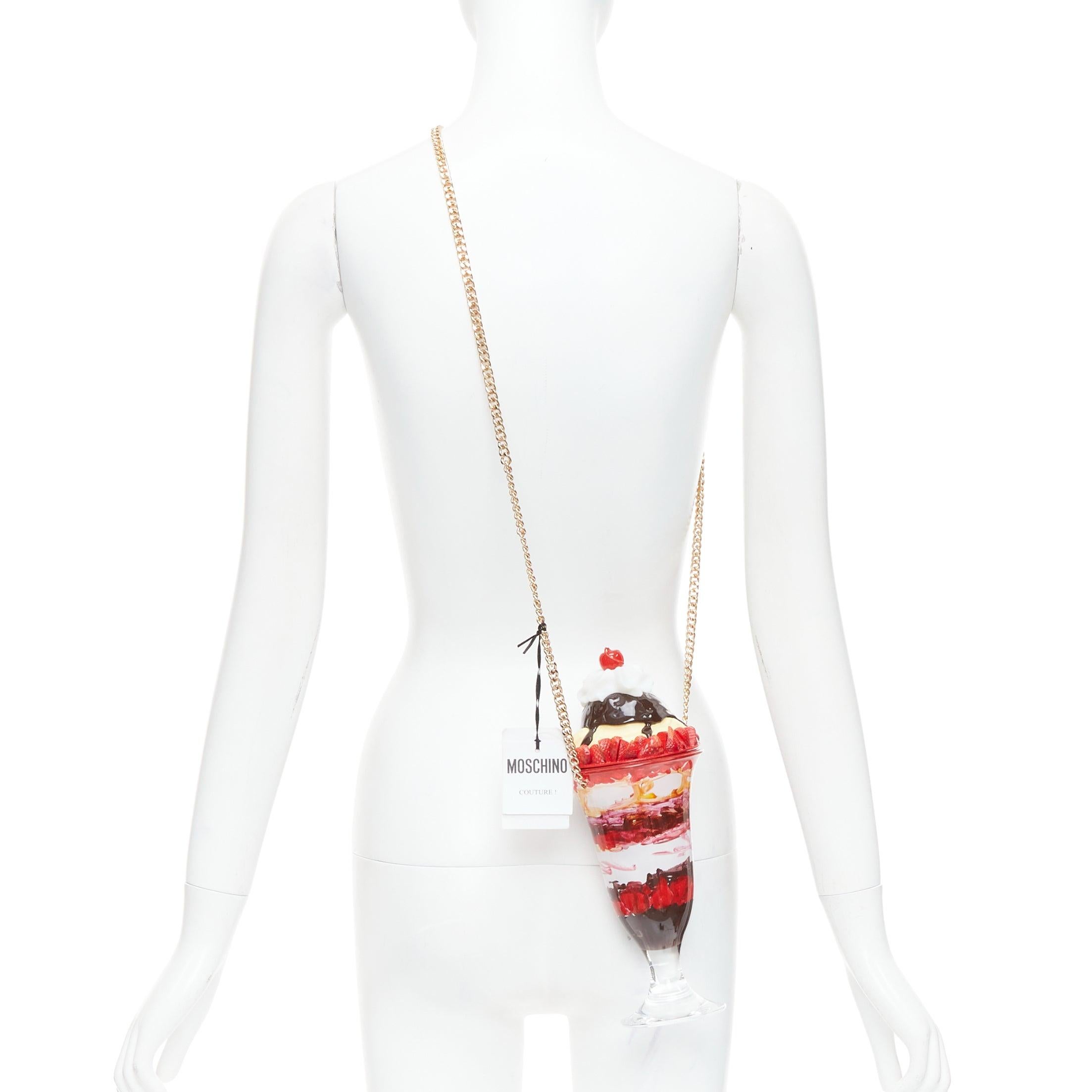 rare MOSCHINO 2022 Ice Cream Sundae Runway pink chocolate chain crossbody bag
Reference: TGAS/E00780
Brand: Moschino
Designer: Jeremy Scott
Collection: SS 2022
Material: Acrylic
Color: Red, Brown
Pattern: Cartoon
Closure: Magnet
Lining: Red 
Extra