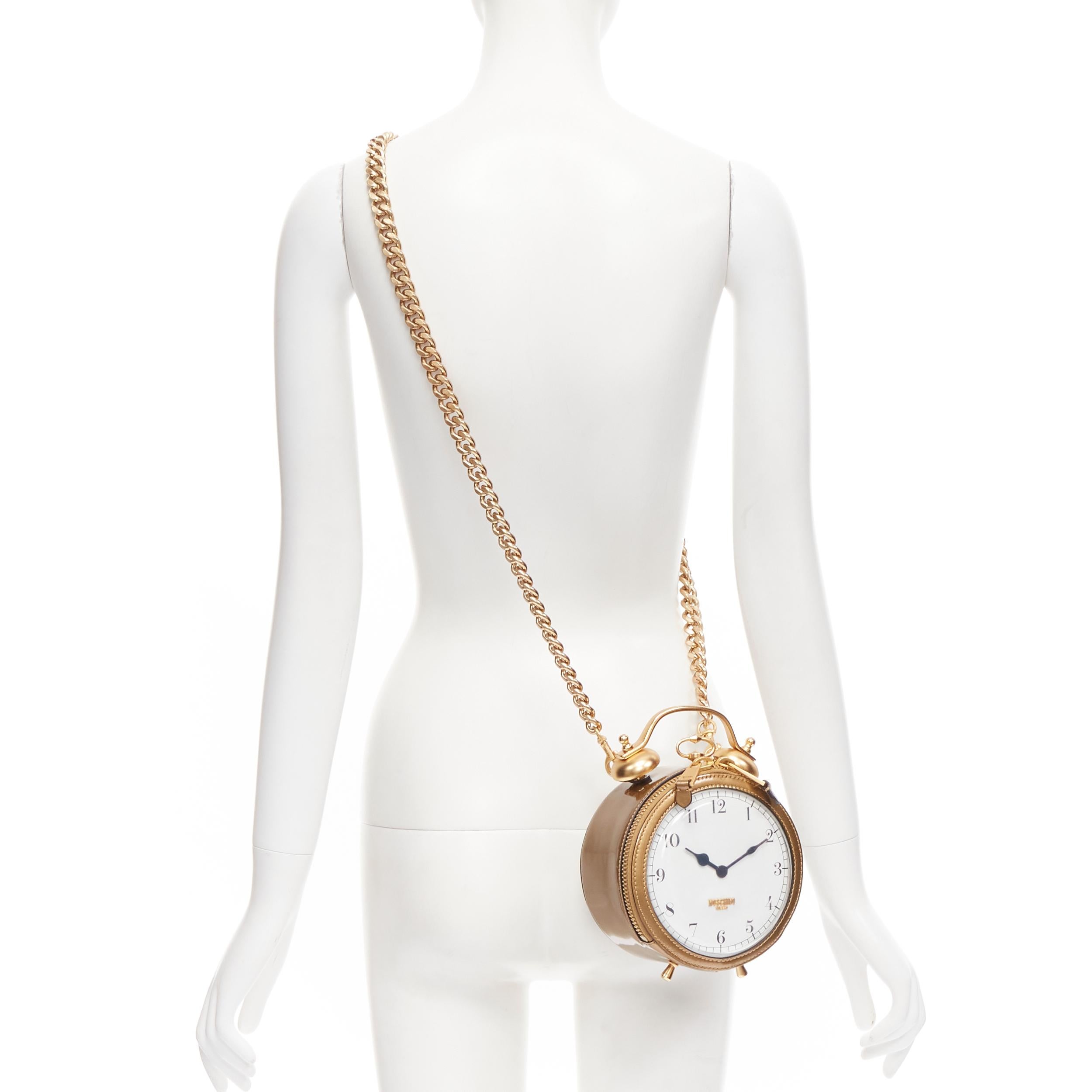 rare MOSCHINO Couture! gold Circus Clock gold top handle crossbody clutch bag 
Reference: TGAS/B02118 
Brand: Moschino 
Designer: Jeremy Scott 
Collection: Fall Winter 2019 Runway 
Material: Patent Leather 
Color: Gold 
Pattern: Solid 
Closure: Zip