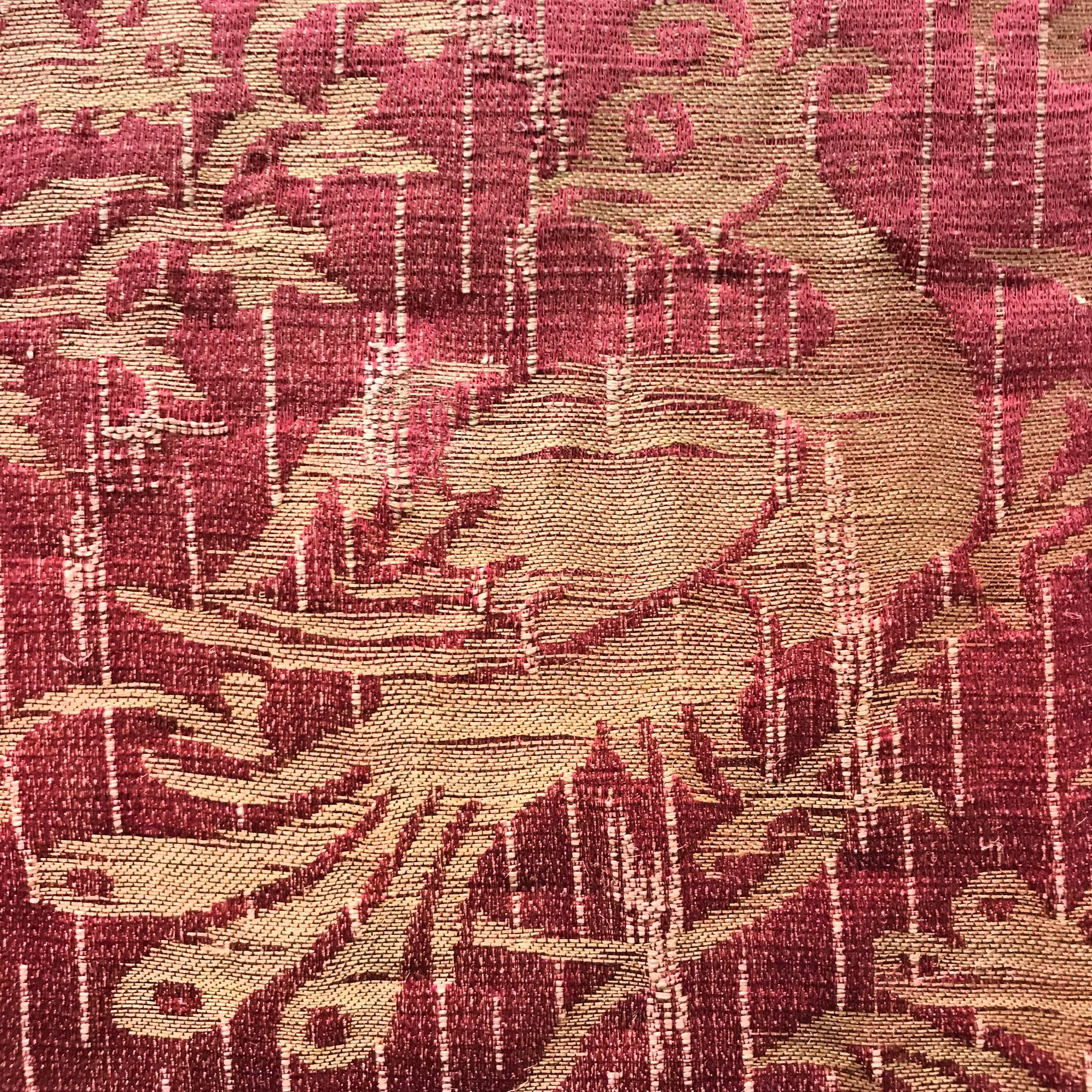 An unbelievably rare 18th century silk damask wall upholstery panel from a grand palazzo in the Umbria region of Italy. The panel contains a beautiful pattern of peacocks, leopards, and elements of Orientalist architecture. The ground is a cranberry