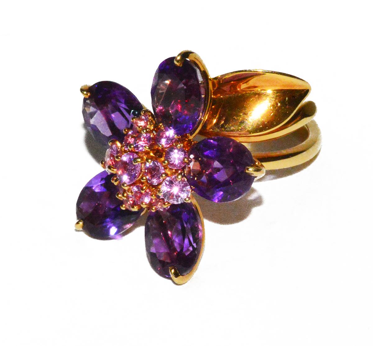 Though a bit difficult to show in pictures, this gorgeous flower ring by VCA rotates and moves.  The petals are amethyst and the stamen is made of pink sapphires. All set in 18K.