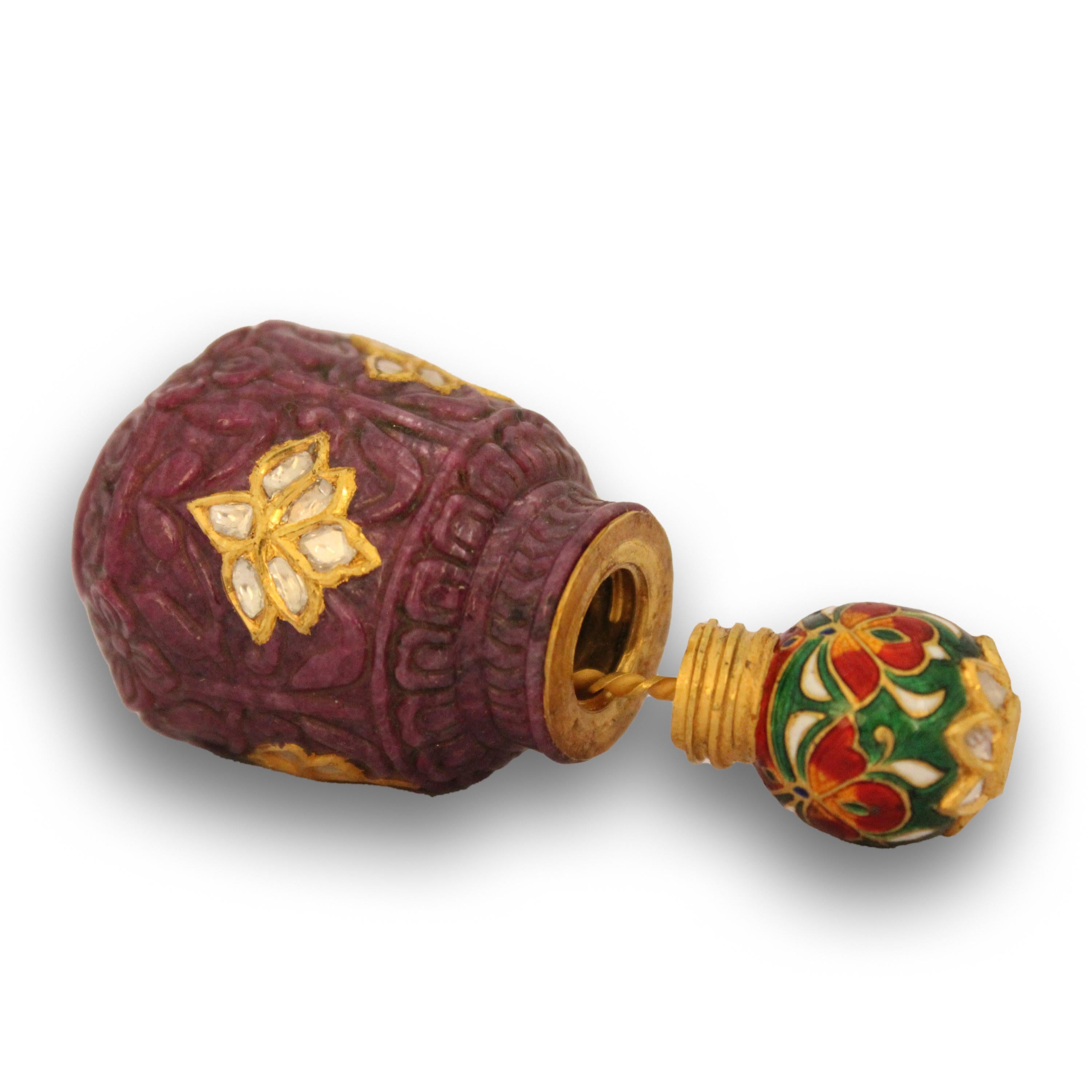 A small rounded bottle is well carved on all sides with flower reserved on a dense ground of leaves. Surrounded at top and bottom with etched motifs of mughal architecture. The stone is perfectly red to justify itself as single ruby piece. Bottle is