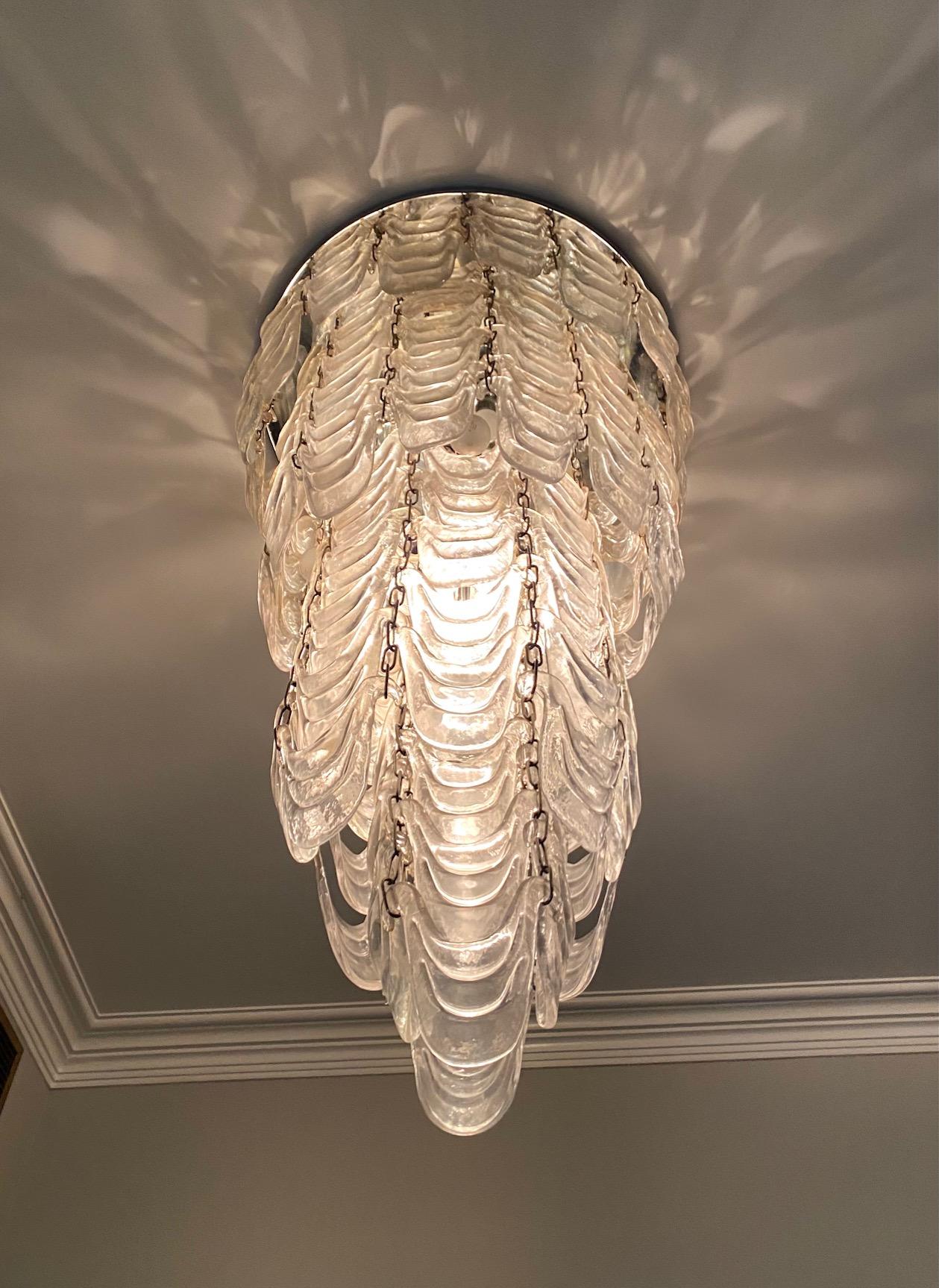 Important cascading  Murano Mazzega moulded glass chandelier consisting of multiple pieces of glass moulded in the form of a swag

Provenance: Estate of Nicole Magder Town of Mount Royal , Montreal Canada. Purchased in Italy by Mme. Magder in the