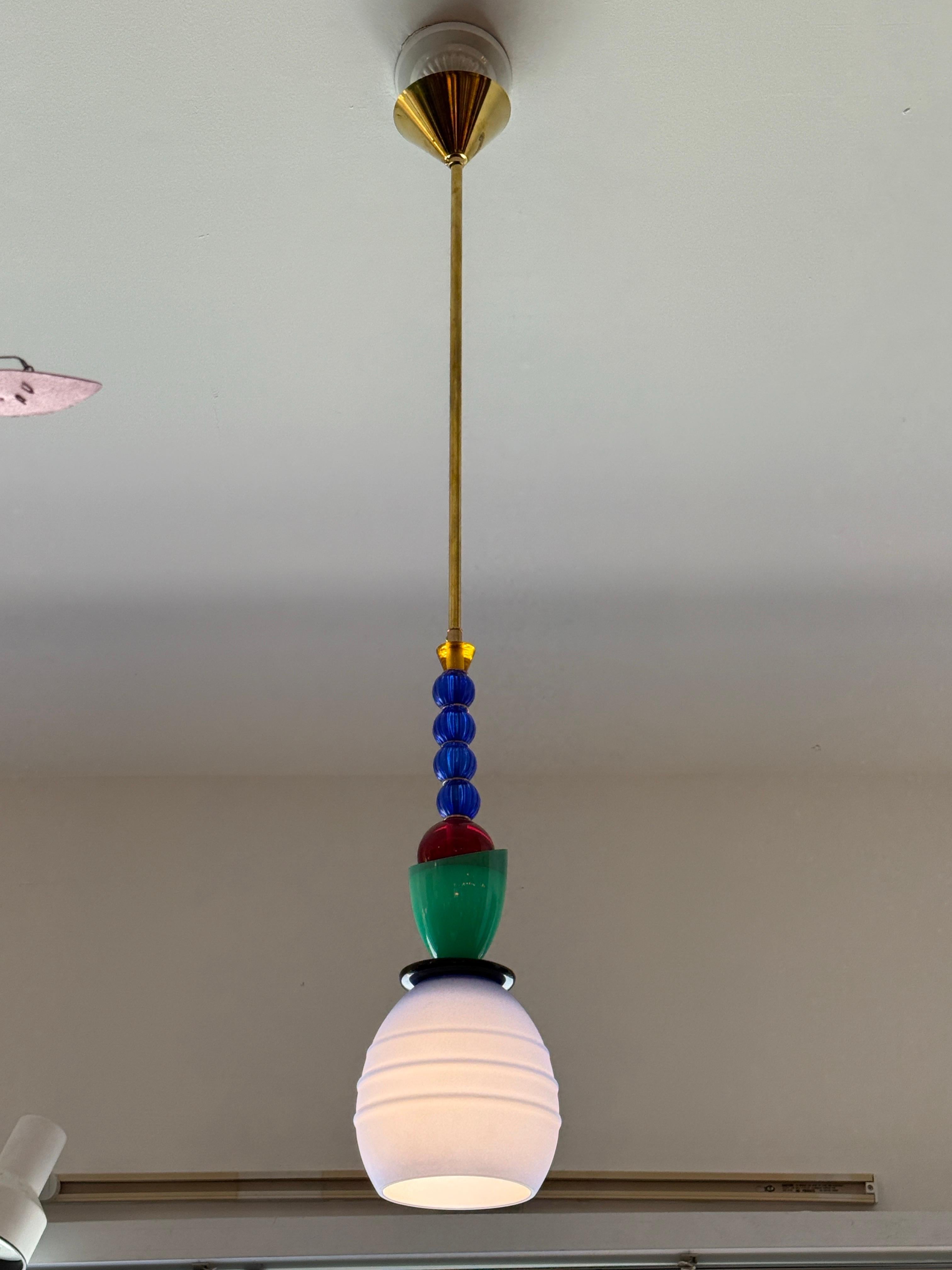 This wonderful 100% unique creation made in Murano, Italy is comprised of vintage Murano glass parts to create this one-of-a-kind pendant light with brass stem and canopy. Royal blue, yellow, red and yellow glass elements.  NOTE:  there is ONE