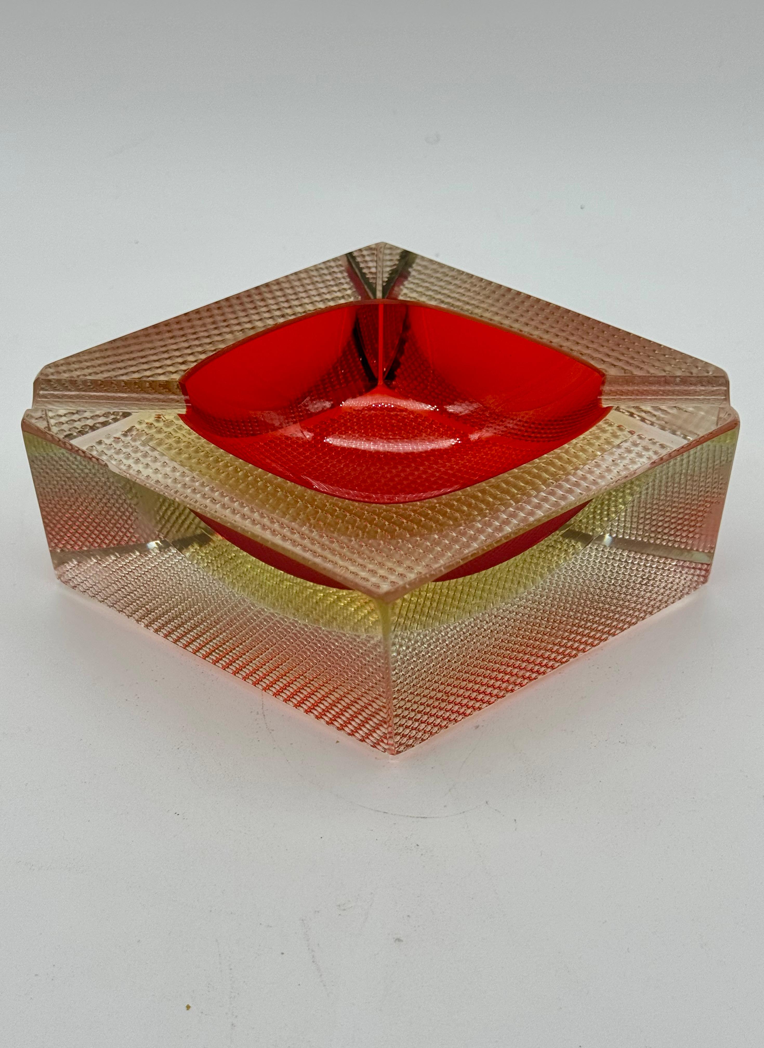 This is an extraordinary and rare Murano ashtray from the 1960s, a collector's piece distinguished by its bold design and unusual composition. The ashtray is attributed to the renowned master glassmaker Flavio Poli and was produced by the