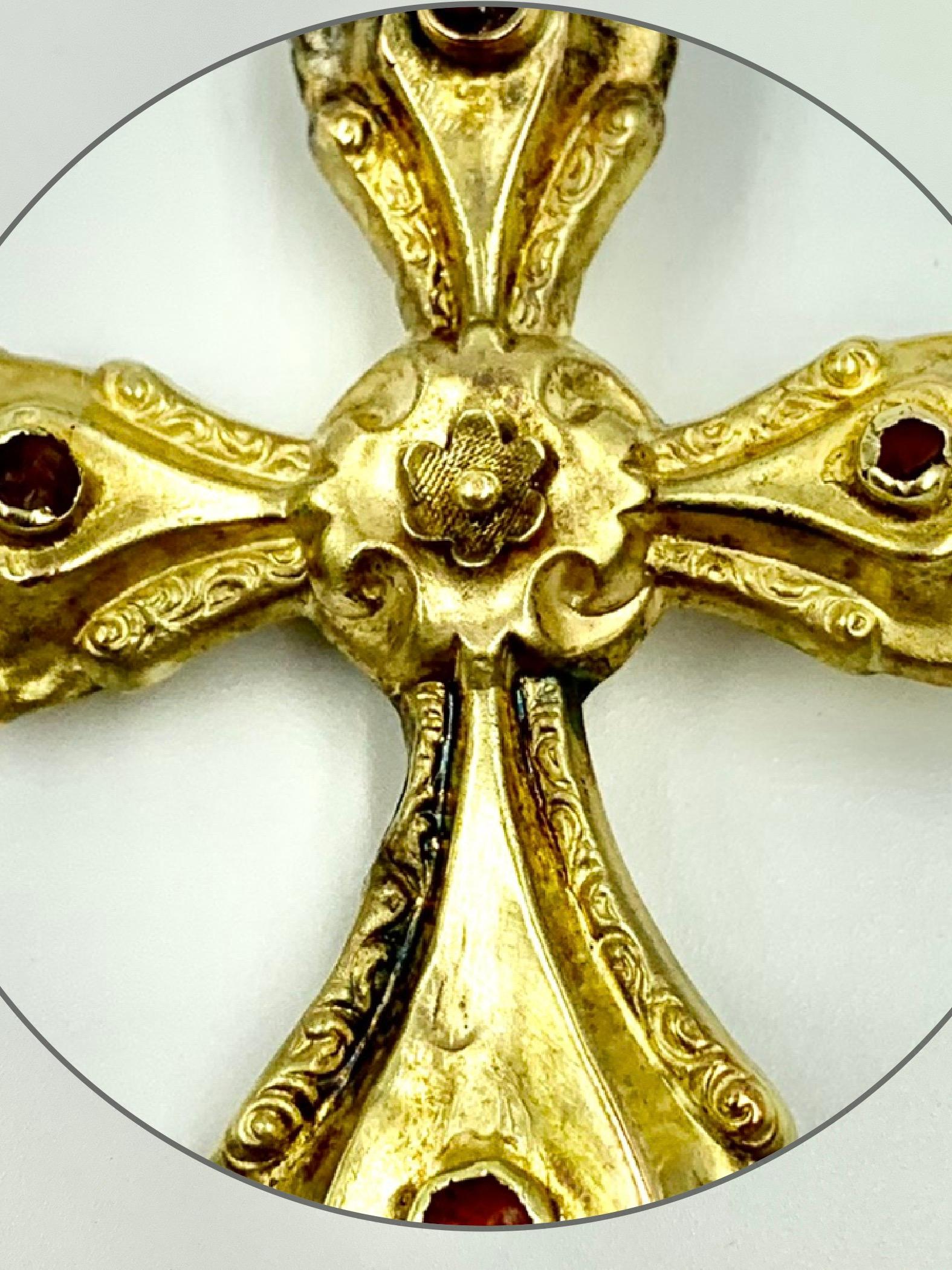Ornate Baroque period museum quality gold cross with cabochon carnelian rondels on each of the arms and an engraved floral center depicting a stylized rose. 
17th Century
The Rose is a symbol of Rosicrucianism, a spiritual and cultural movement