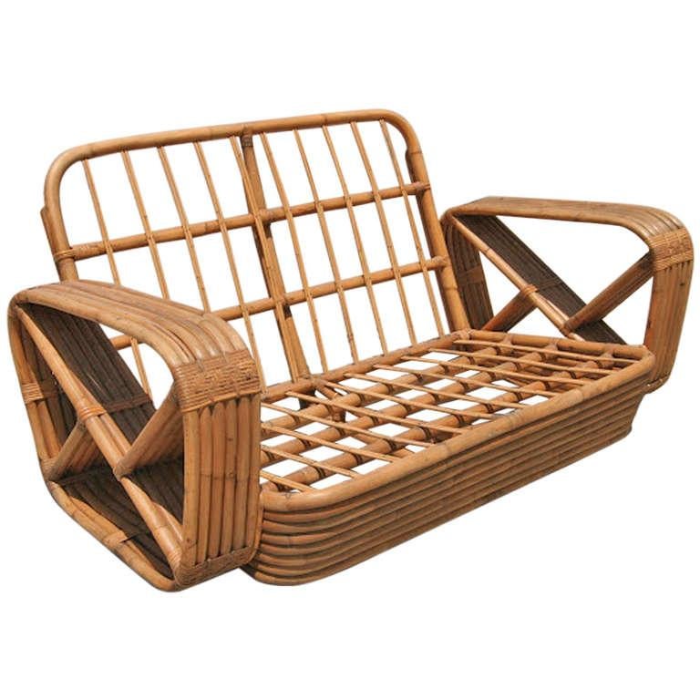 Paul Frankl six-strand square pretzel rattan arm settee. This loveseat settee dates from 1934. This comes directly for a Paul Frankl decorated house located in Los Angeles and is documented.


Custom cushions C.O.M. (Costumers Own Material) are